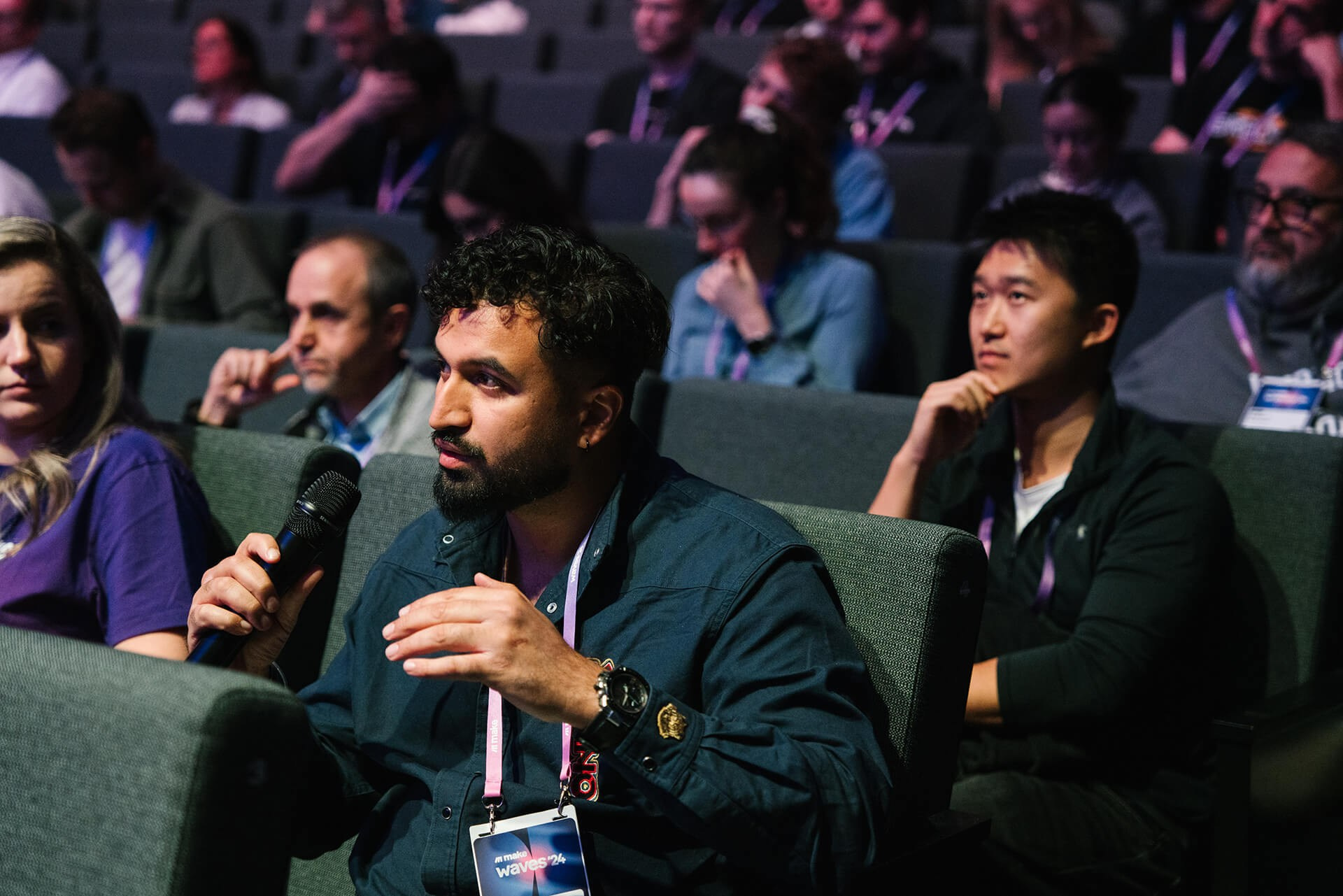 Attendee asking a question during an interactive conference session
