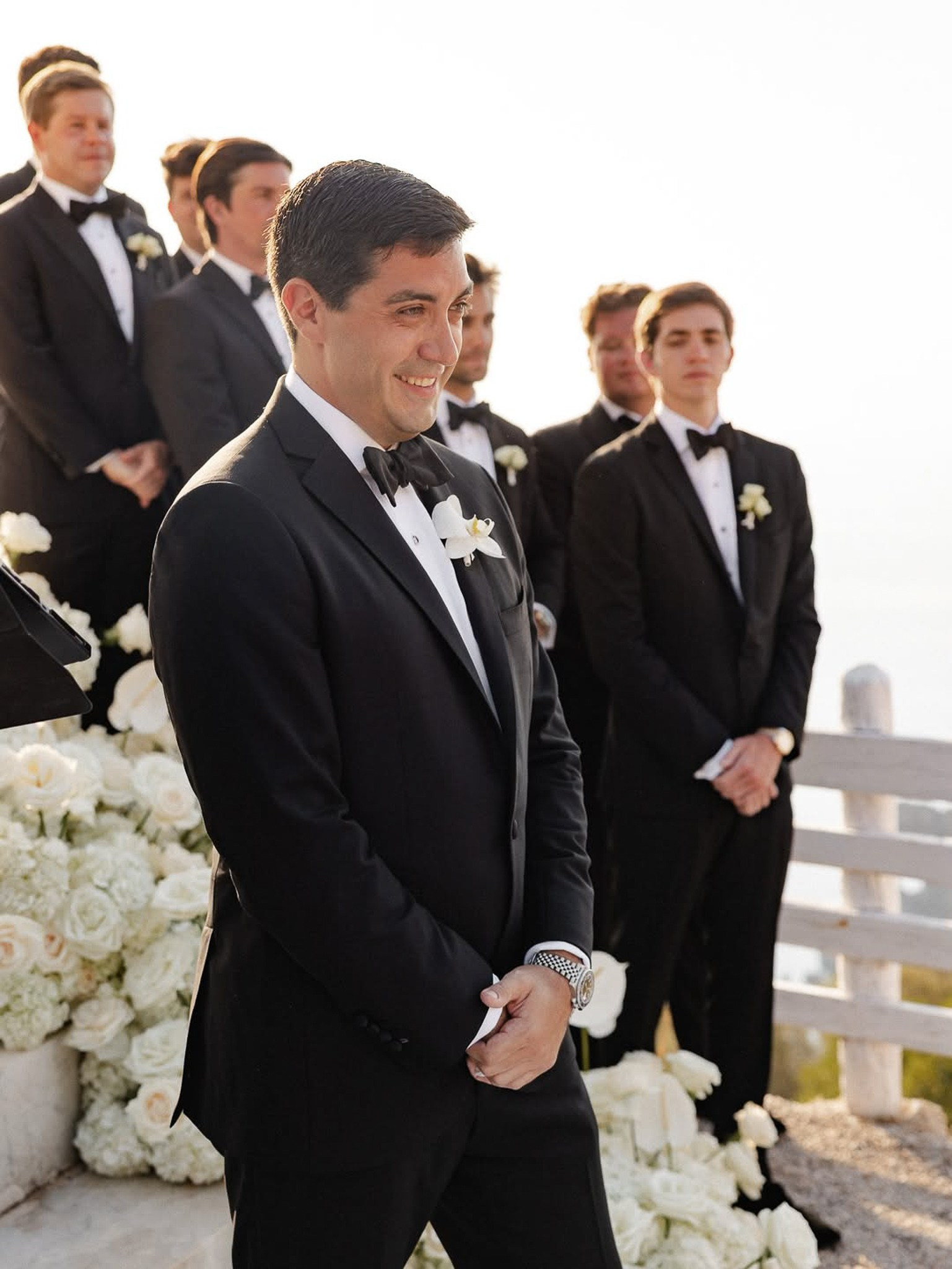 Groom smiling with his groomsmen standing behind him during the wedding ceremony at Son Marroig