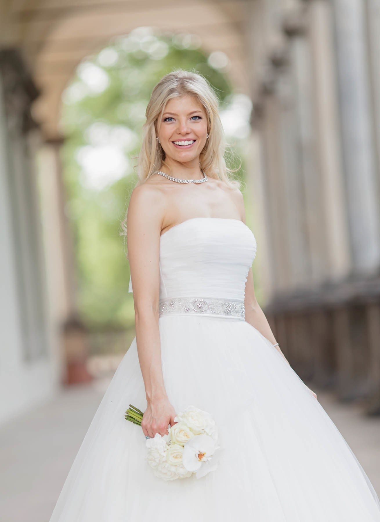 Close-up portrait of bride holding white rose bouquet soft Prague light