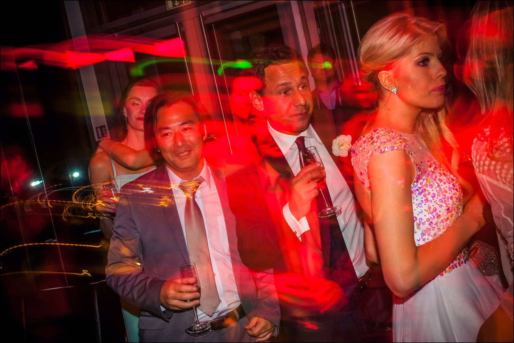 Happy guests in colorful club lighting afterparty Four Seasons Prague