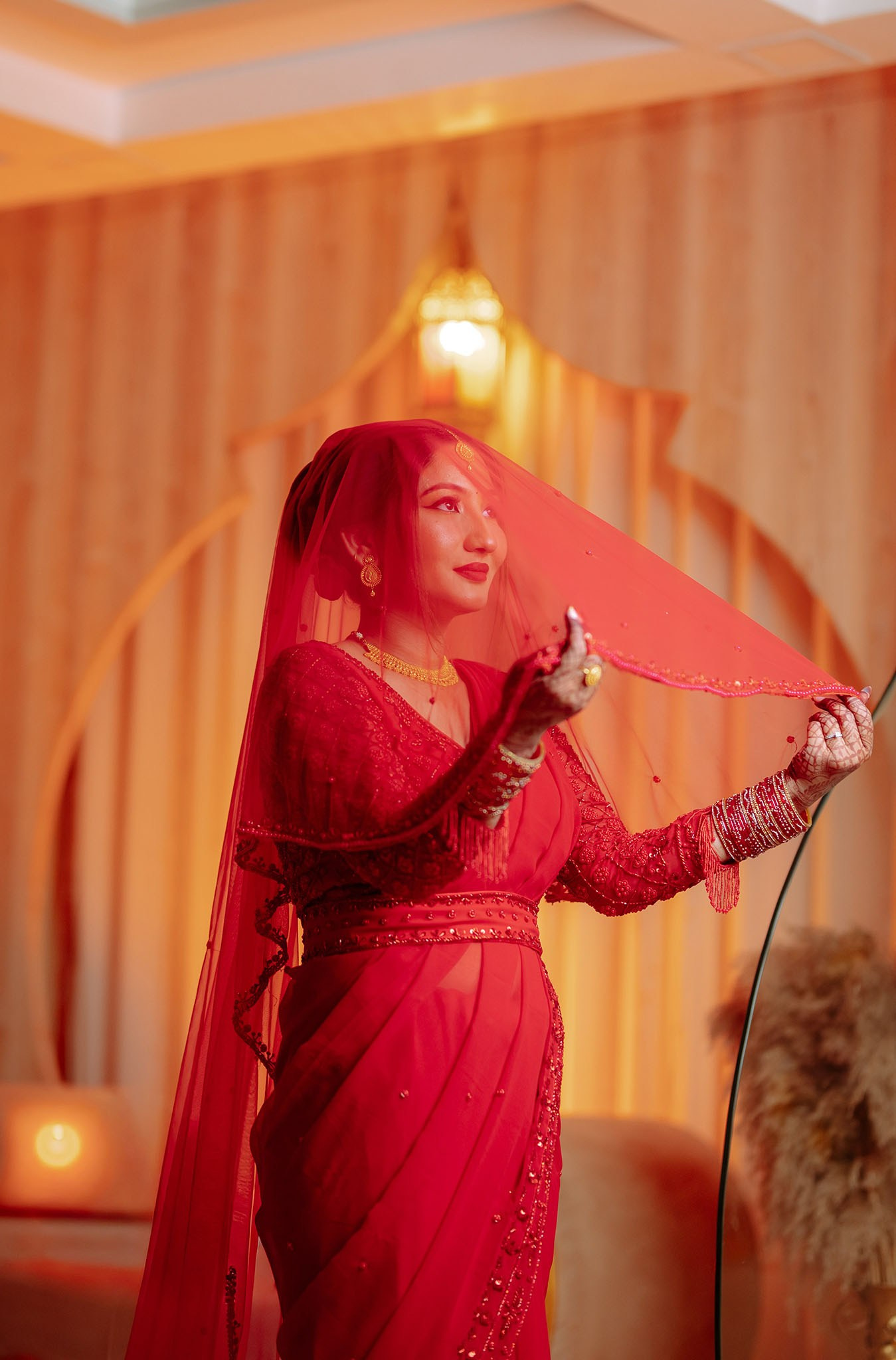Beautiful Nepali bride in a vibrant red embroidered saree and gold jewelry, photo by poudel digital photography Butwal Nepal.