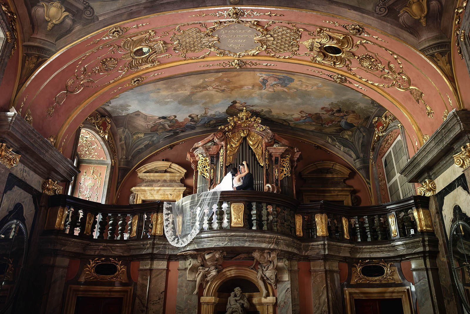 A view looking up towards the Mirror Chapel organ, where newlyweds from China are in a loving embrace