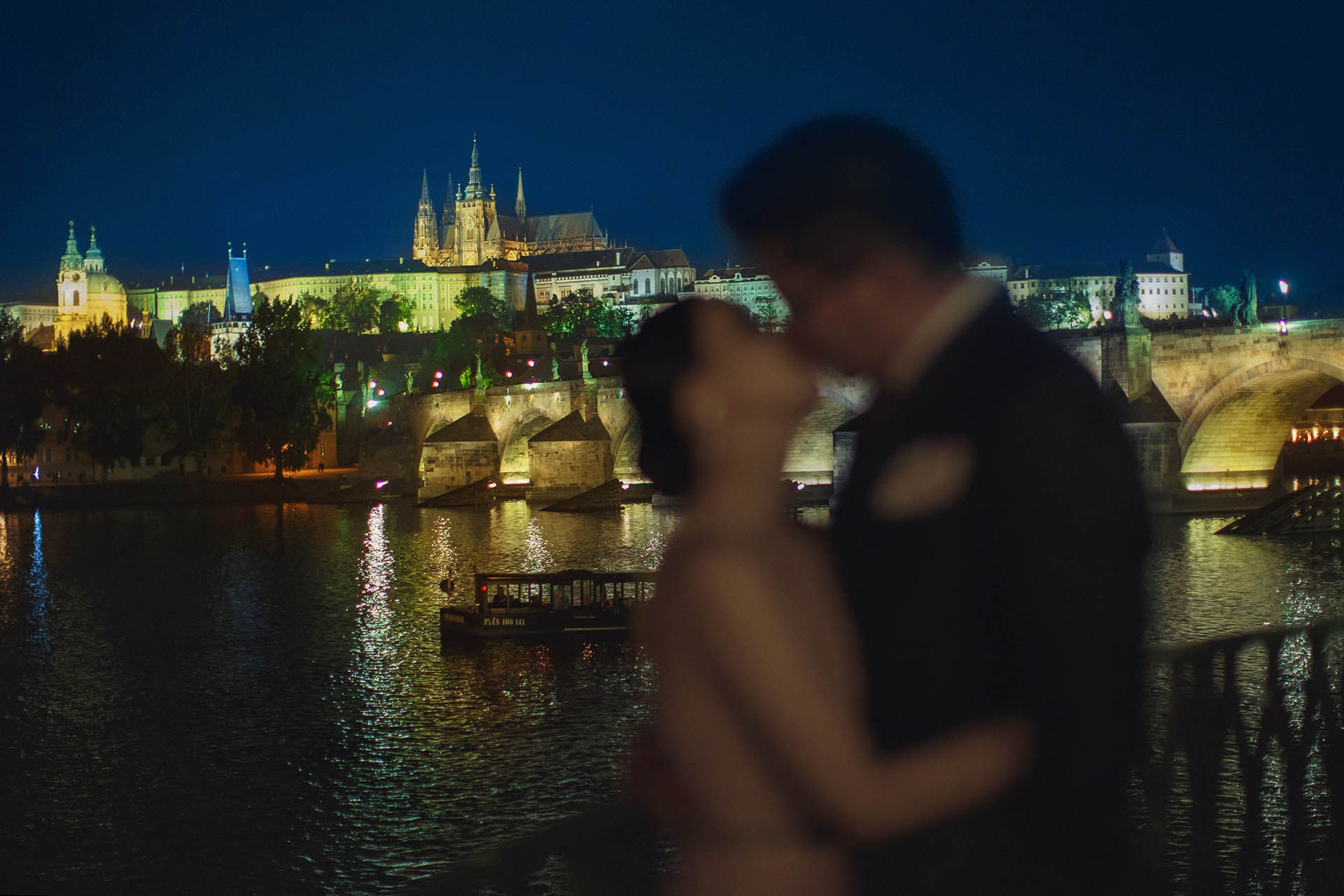 Catherine Cedric Son silhouette kiss Prague Castle Charles Bridge view portrait.