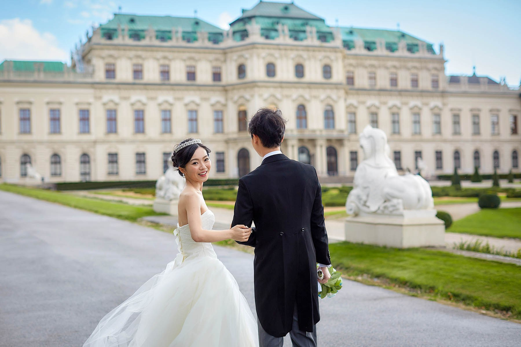 Bride looking back happily at the Belvedere Palace Vienna.
