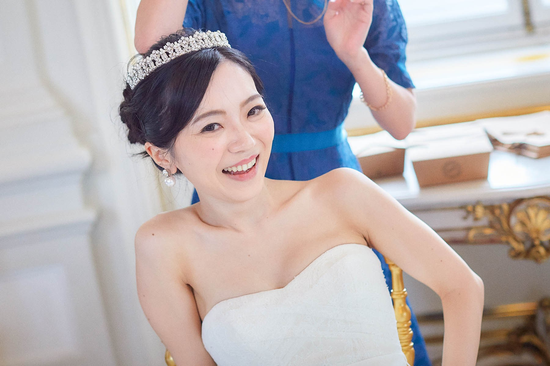 Happy bride laughing seated at wedding reception Vienna.