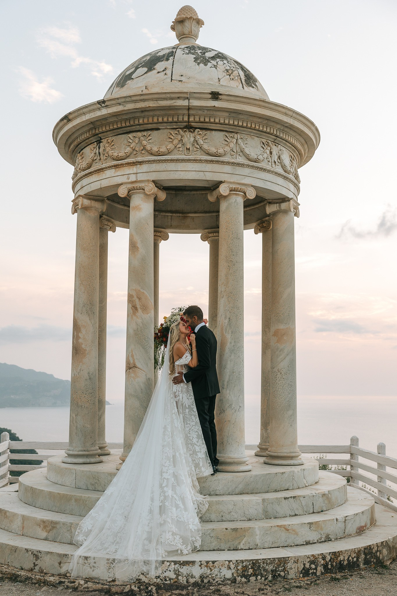 Bride and groom kissing inside the Son Marroig temple at sunset after their Mallorca wedding