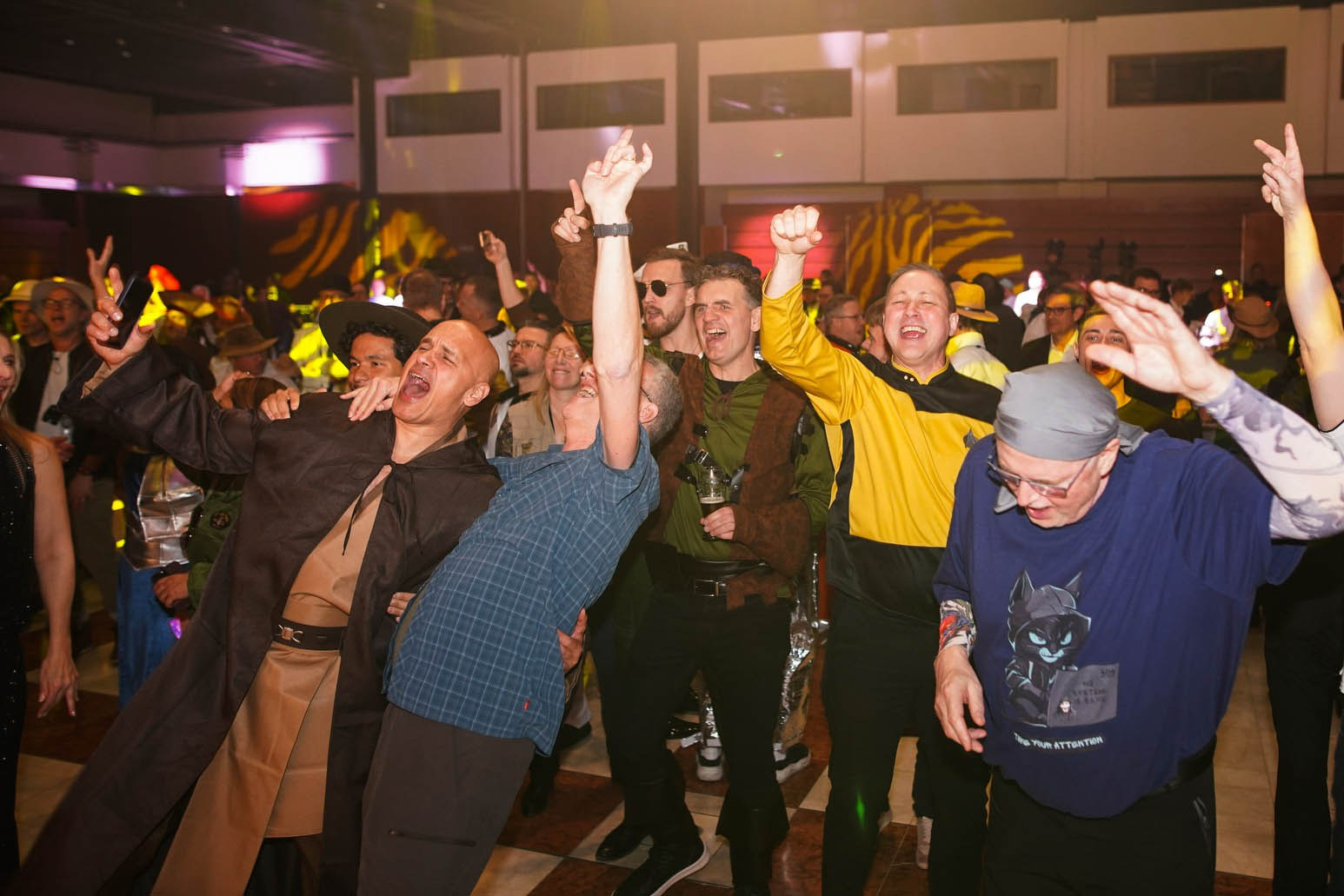 Delegates dancing and revelling during live band performance at Orange Business gala dinner Hilton Prague 2026.