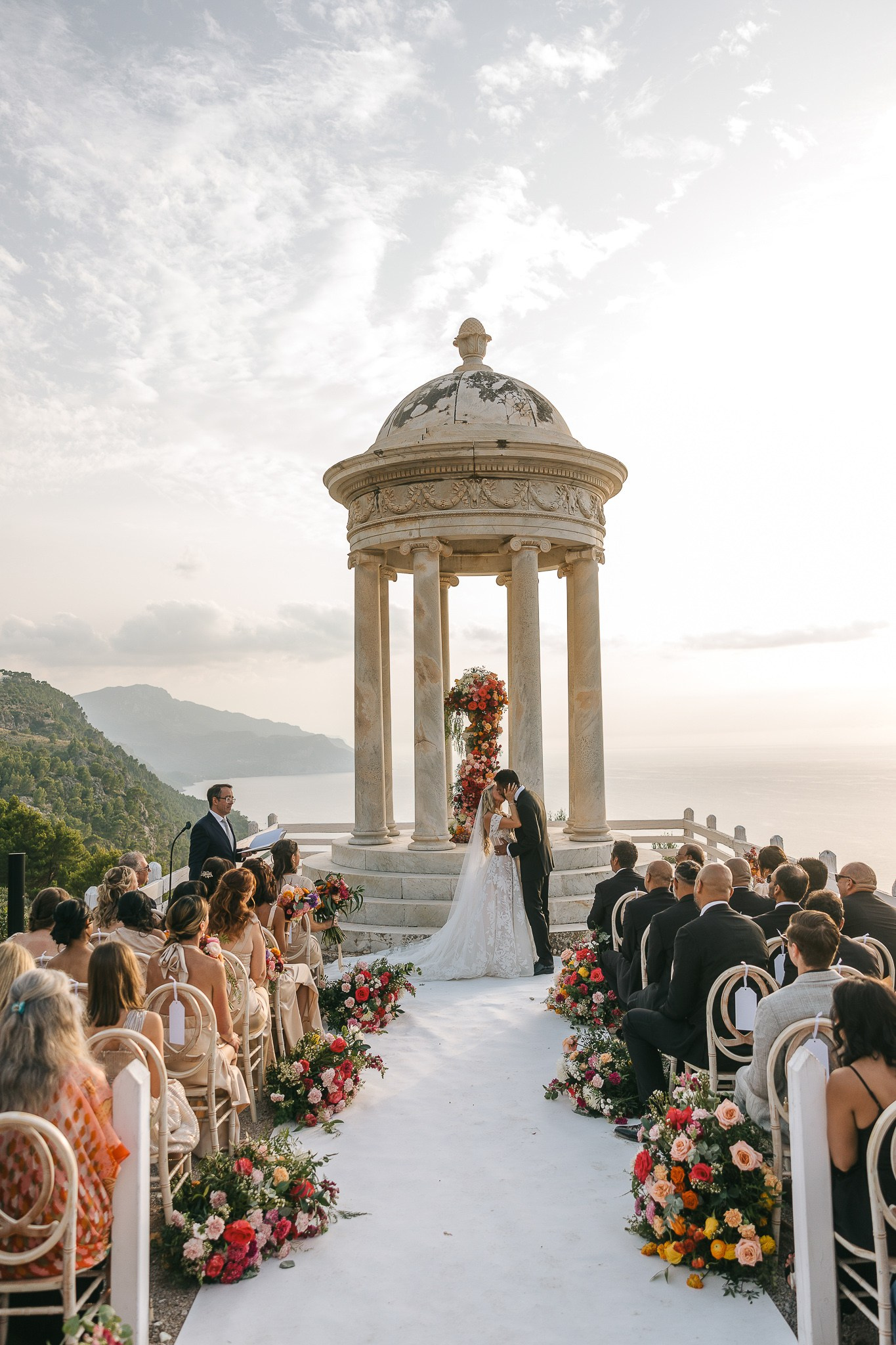 Bride and groom kissing at the altar during their custom wedding ceremony at Son Marroig