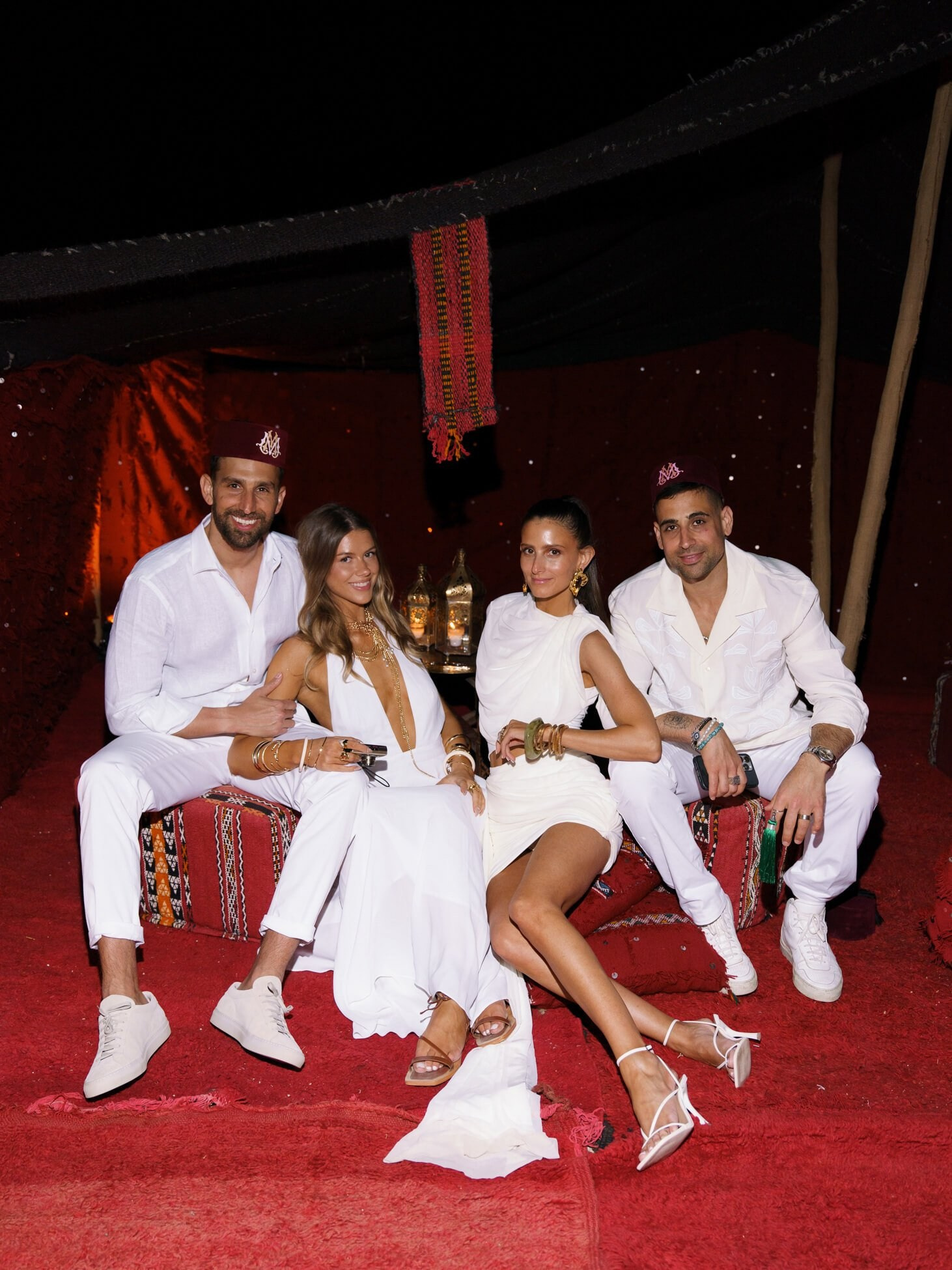 Guests seated inside tent during destination desert wedding reception, Morocco