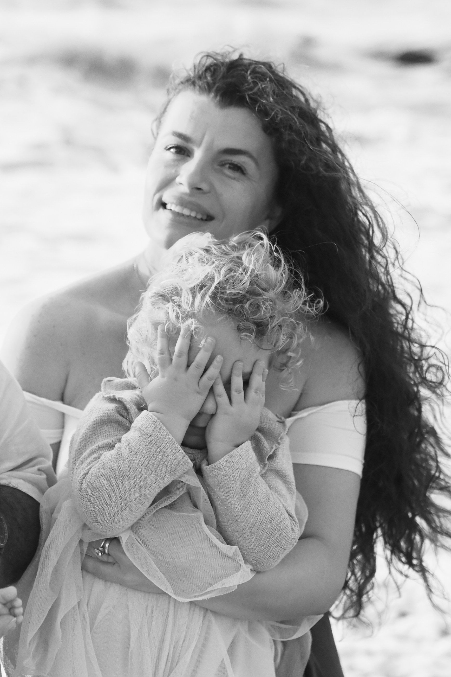 Happy family walking along a Rhodes beach at sunset. Photographer in Rhodes Island