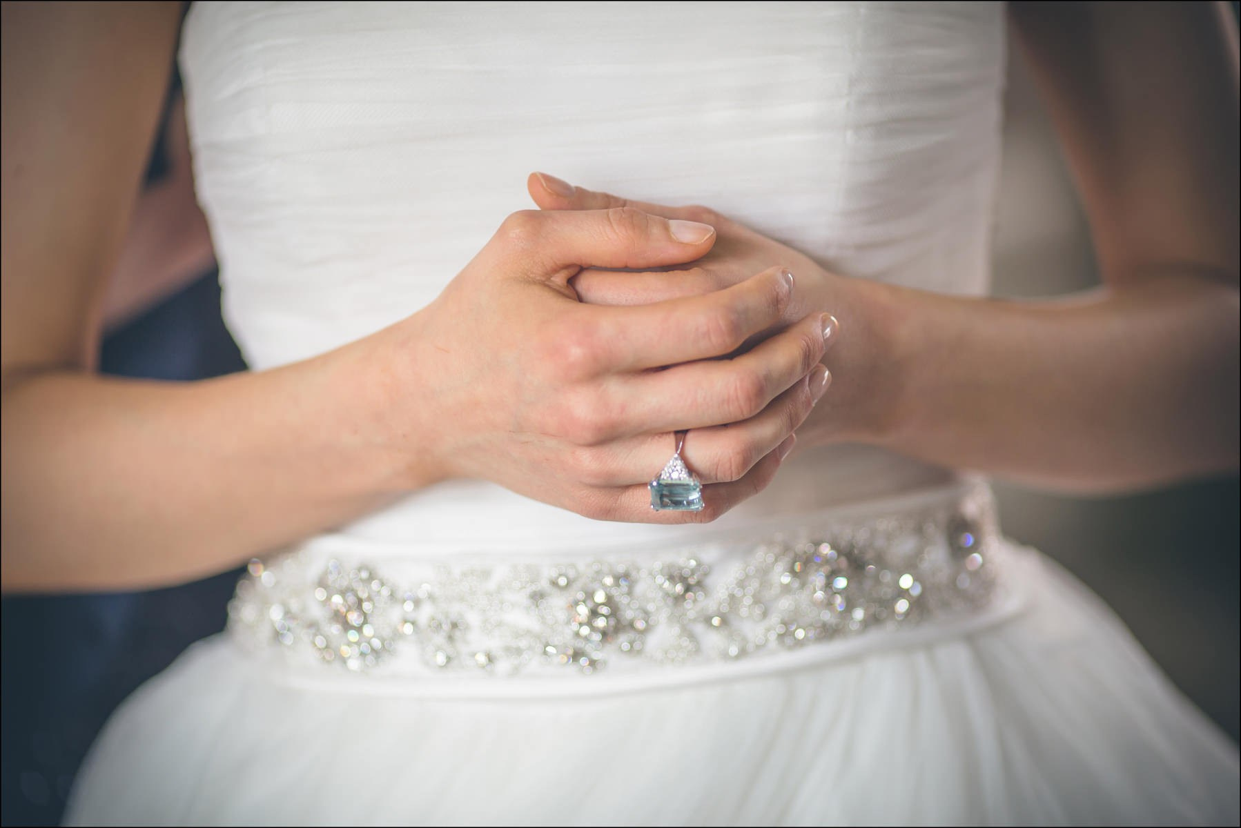 Bride's hands showing gentle anticipation during final wedding preparations in Prague