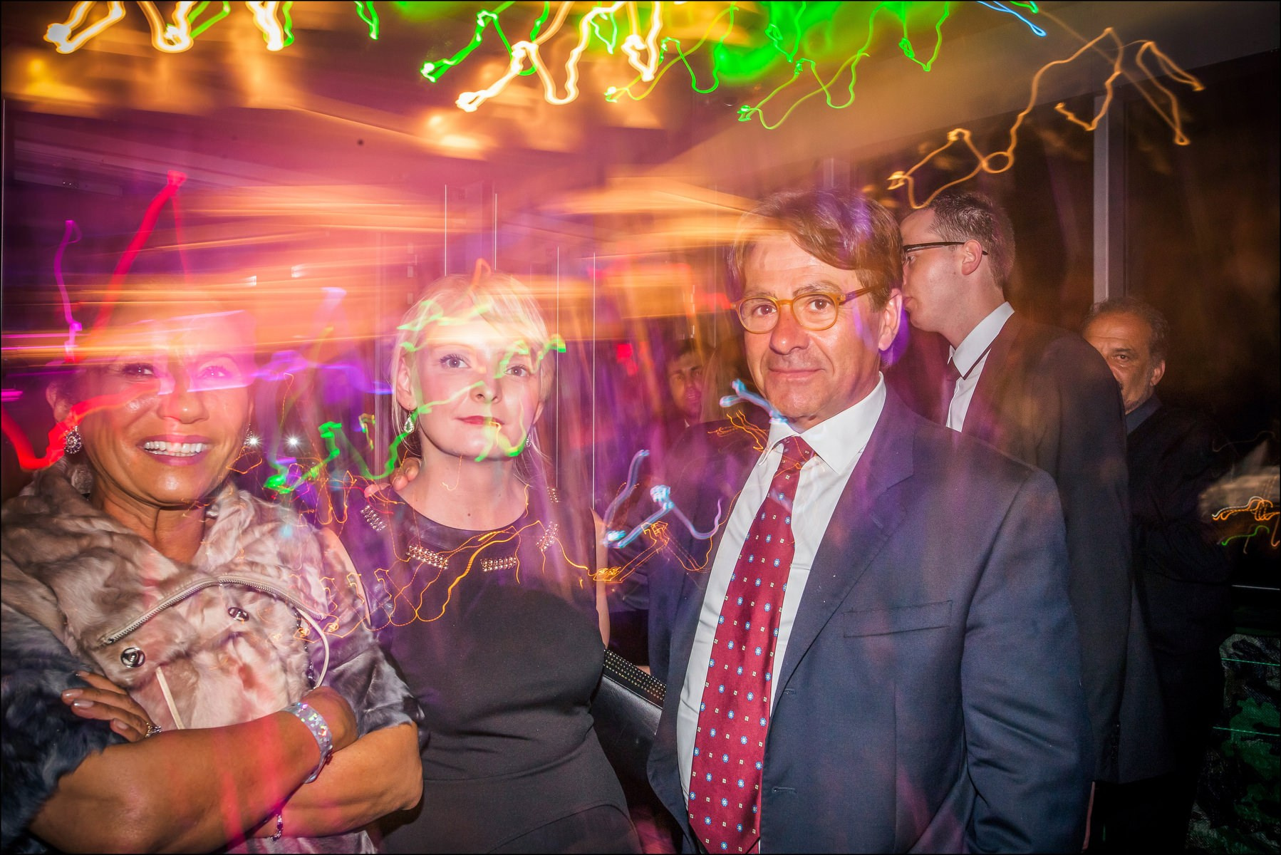 Couples standing in colorful club atmosphere wedding party Prague