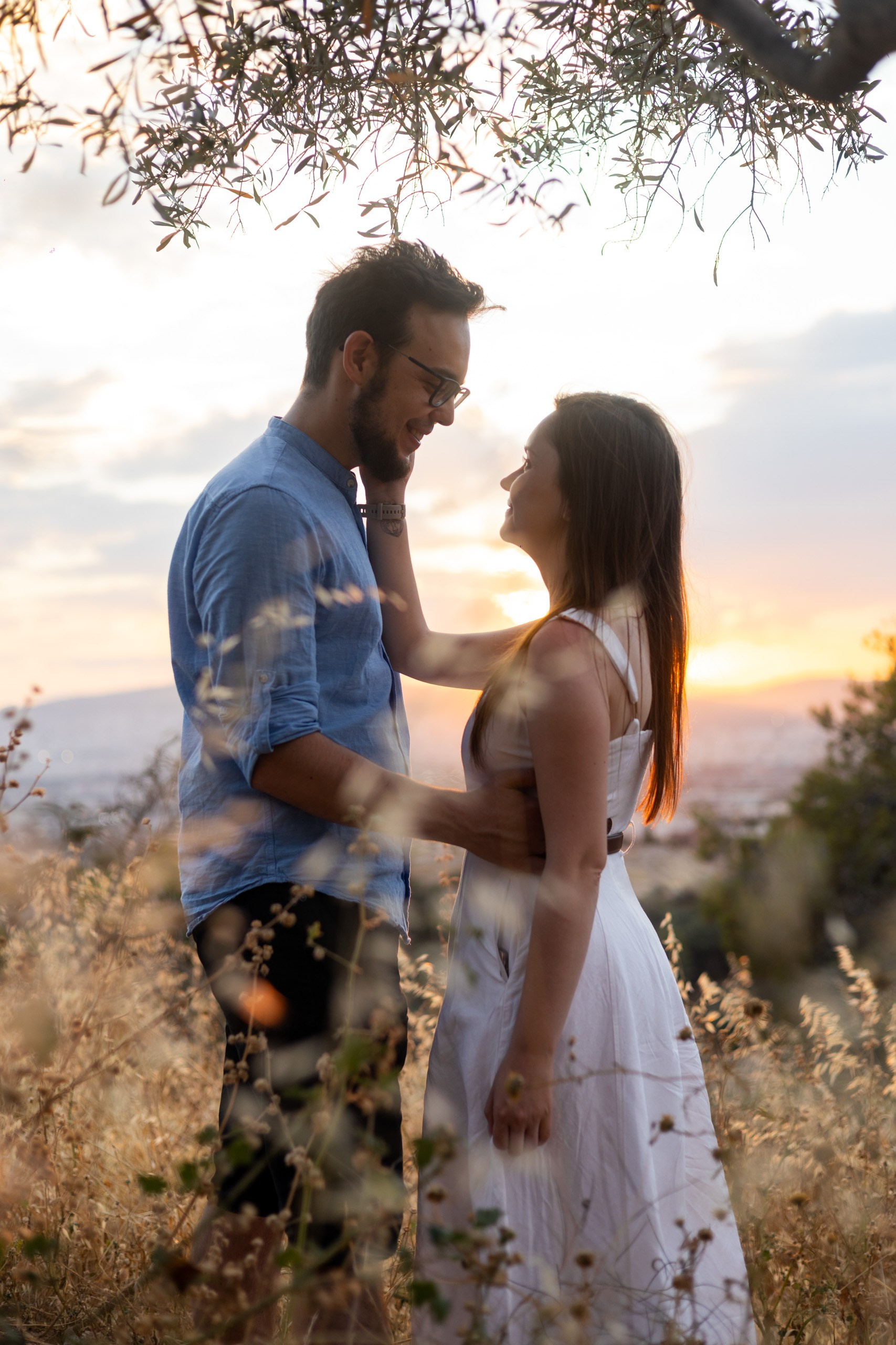 Couple holding hands during a sunset walk in Athens