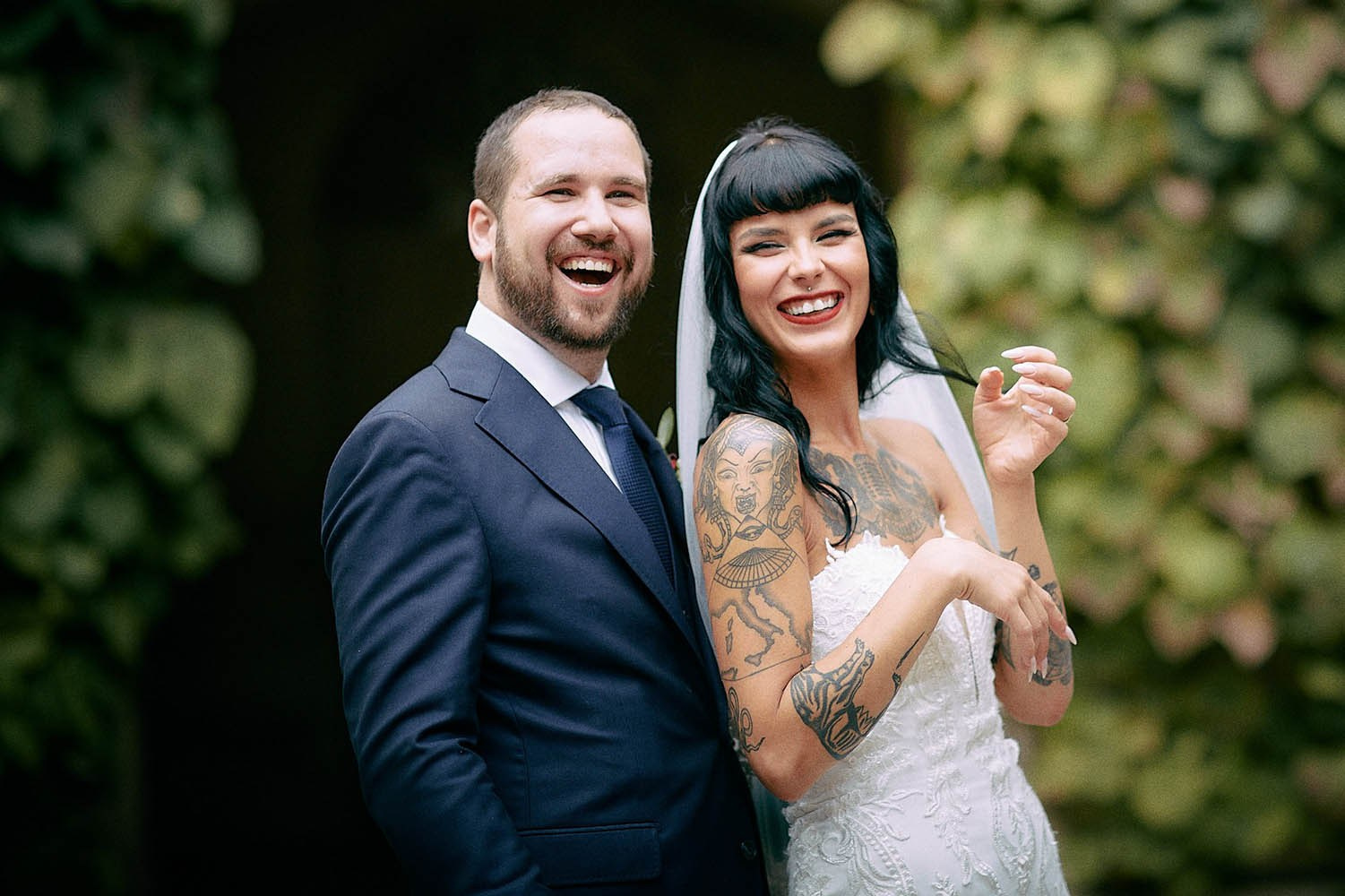 A couple laughing joyfully in the historic Grebovka vineyard grotto in Prague.