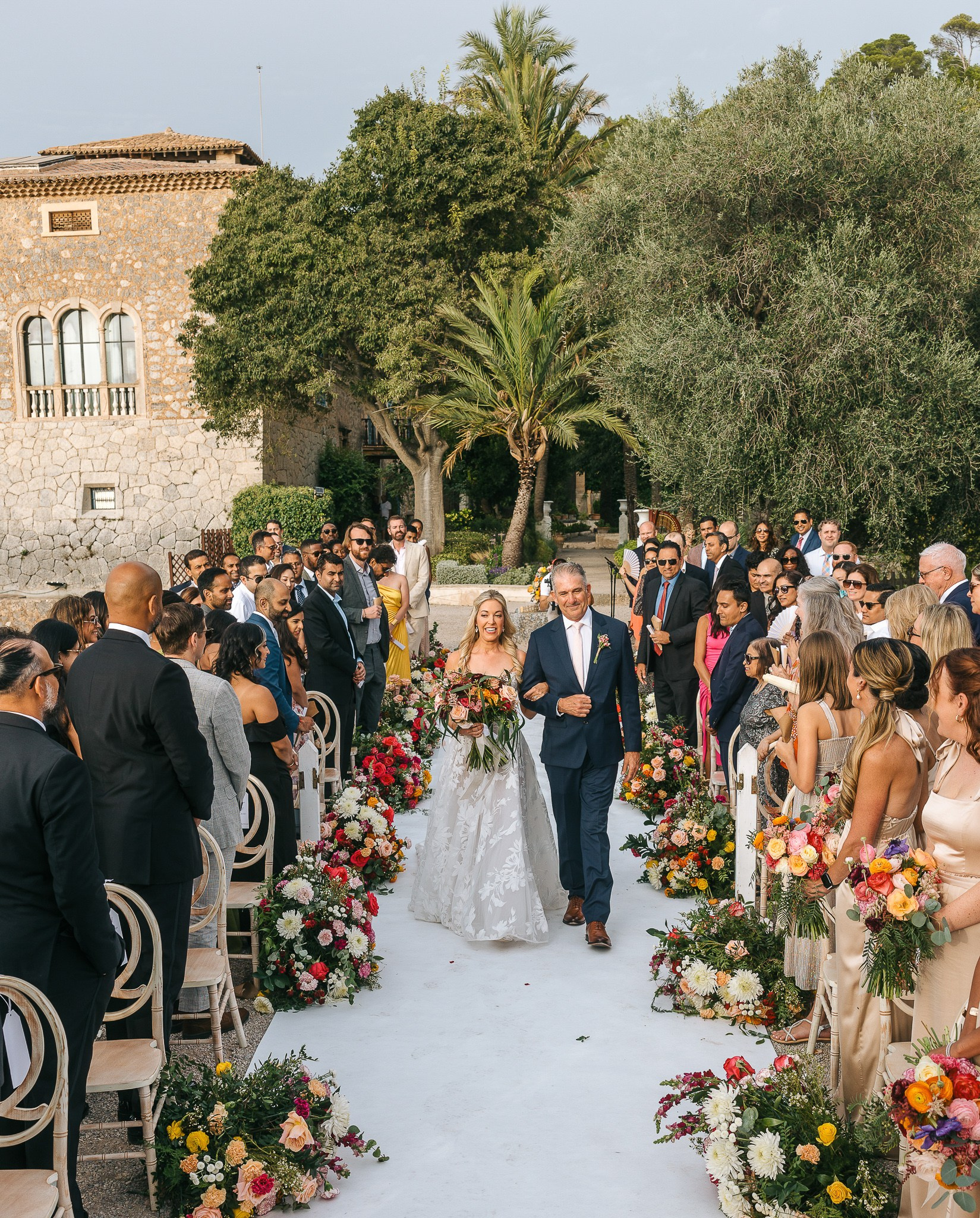 Bride approaching the Son Marroig temple during her Mallorca destination wedding ceremony