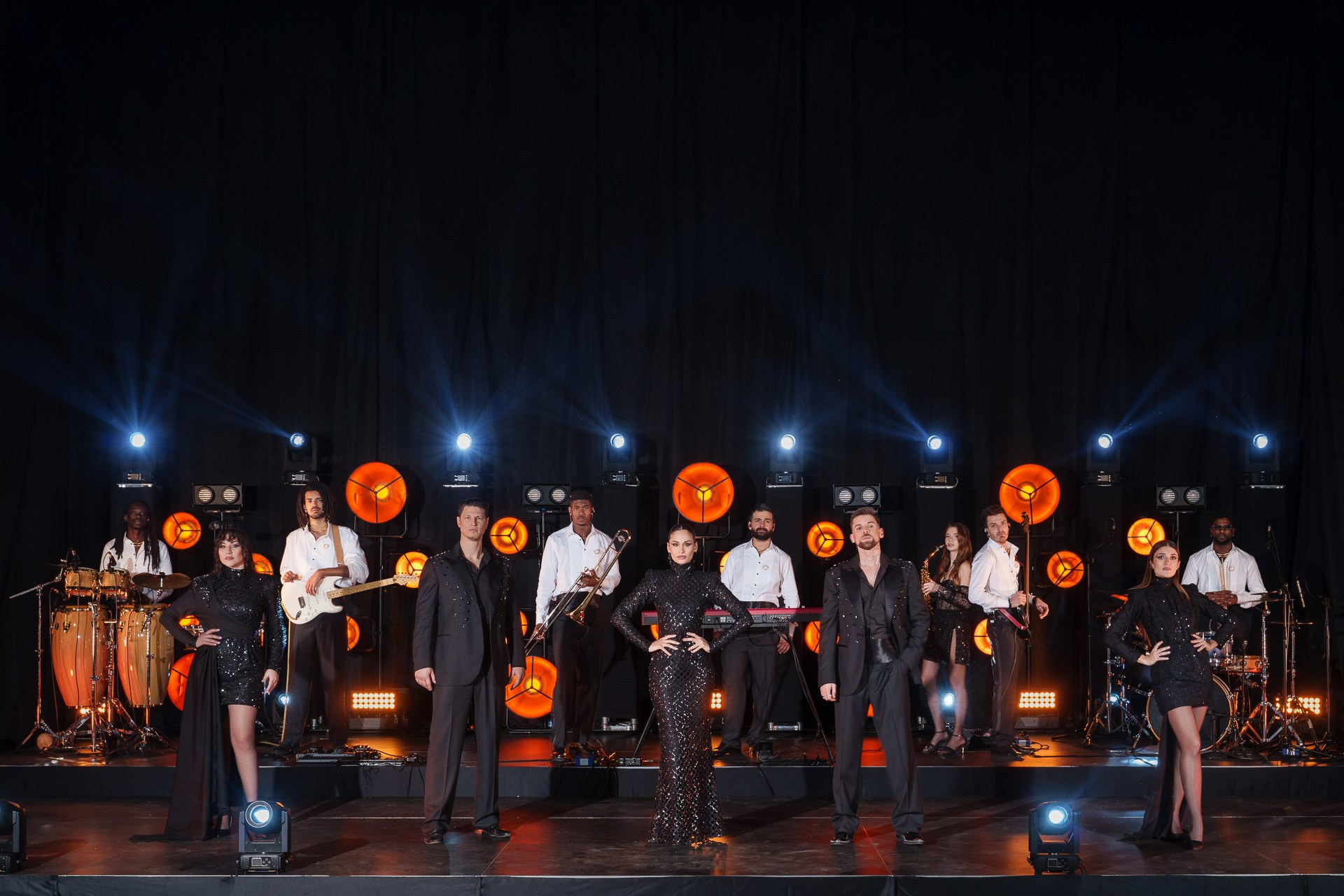 Professional music band performing live on stage with high-end lighting at a corporate gala event in Milan