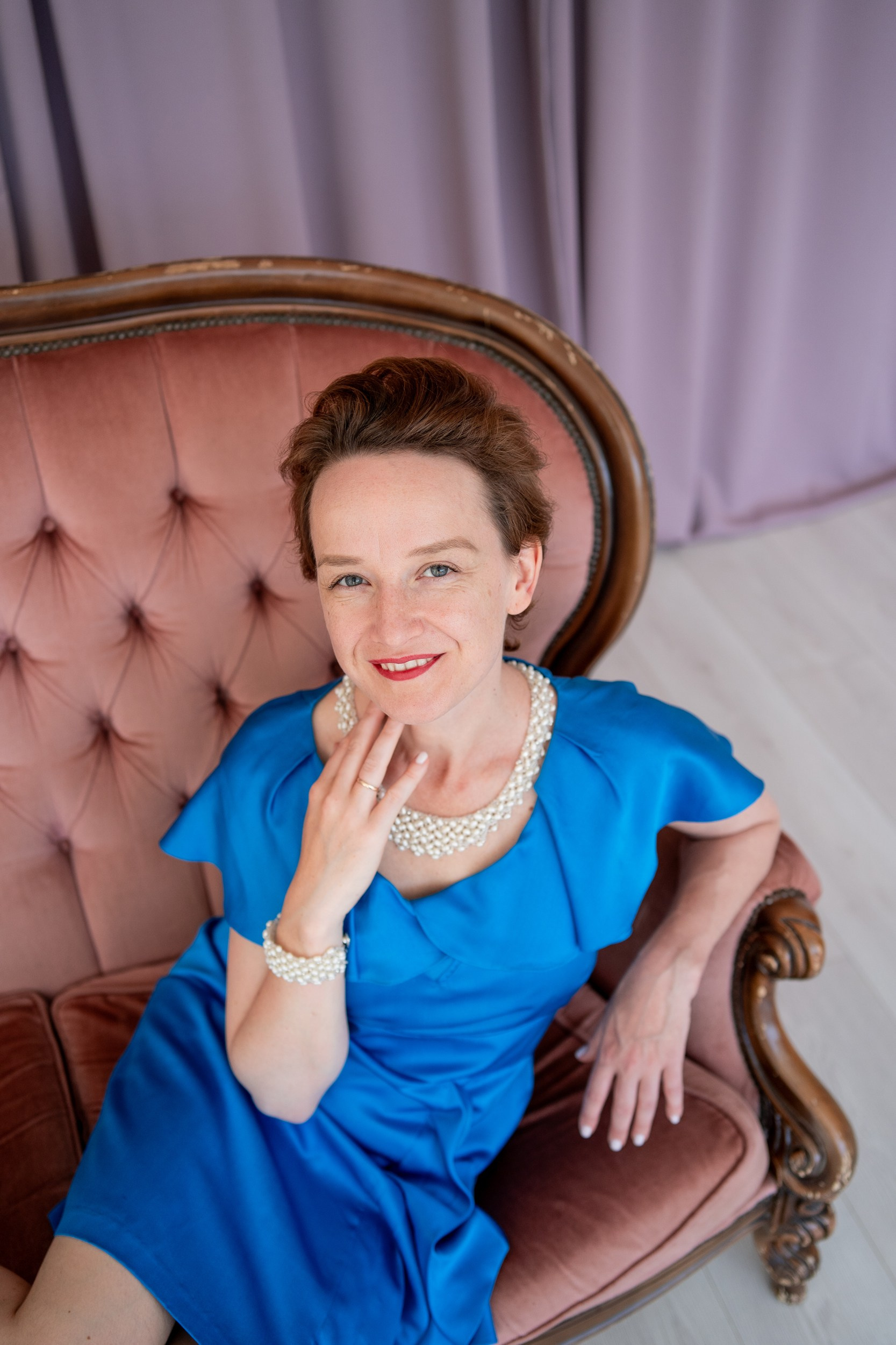 Woman in a dress sitting on a couch