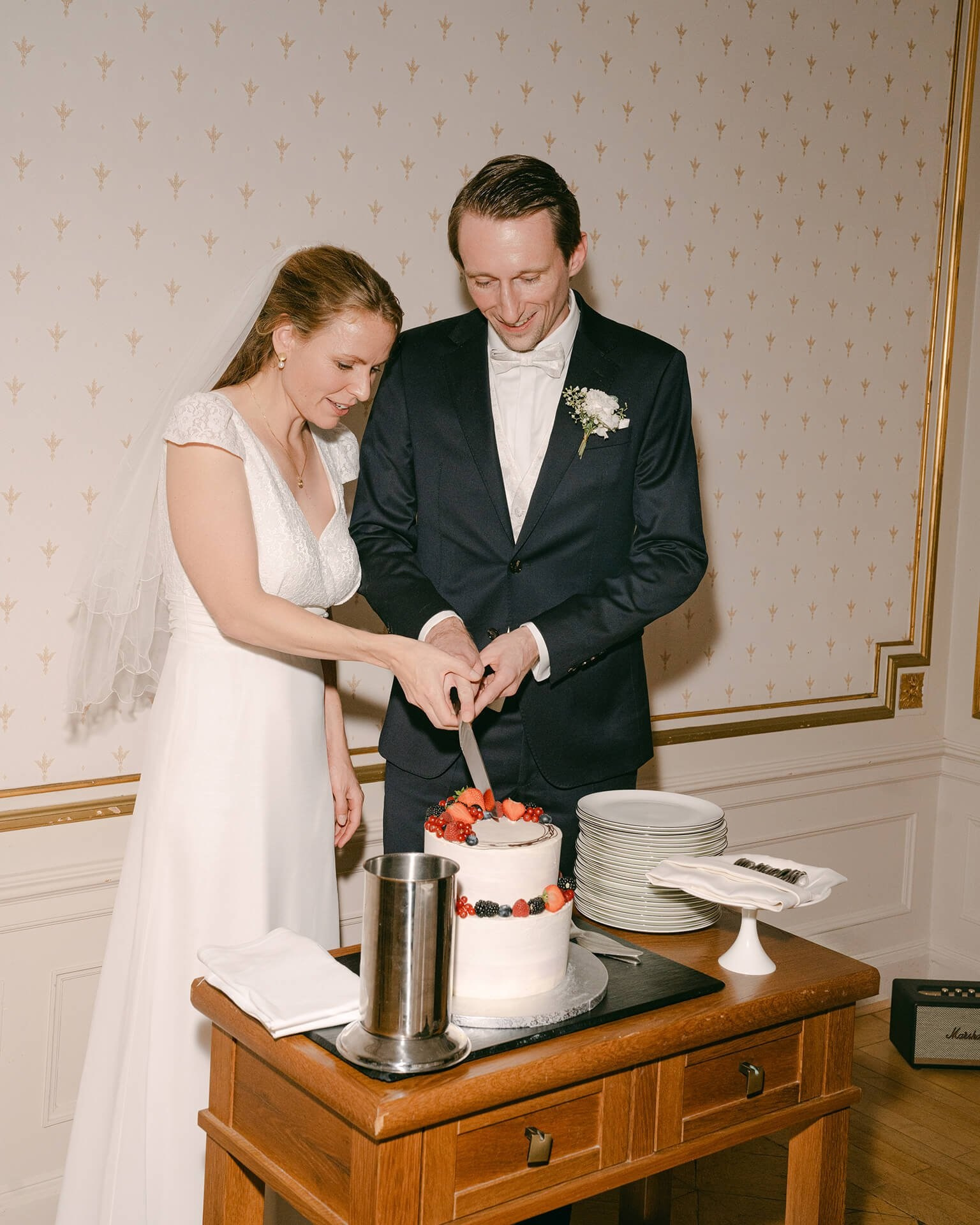 Couple cutting cake indoors, luxury wedding reception at Falkenstein Grand