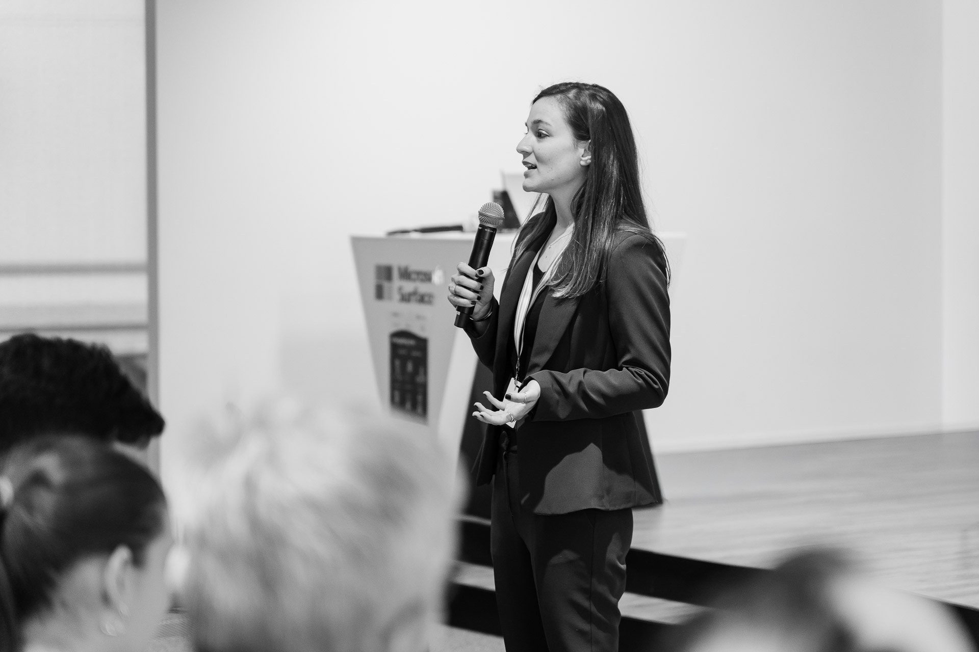 Corporate event speaker presenting during a business conference in Milan
