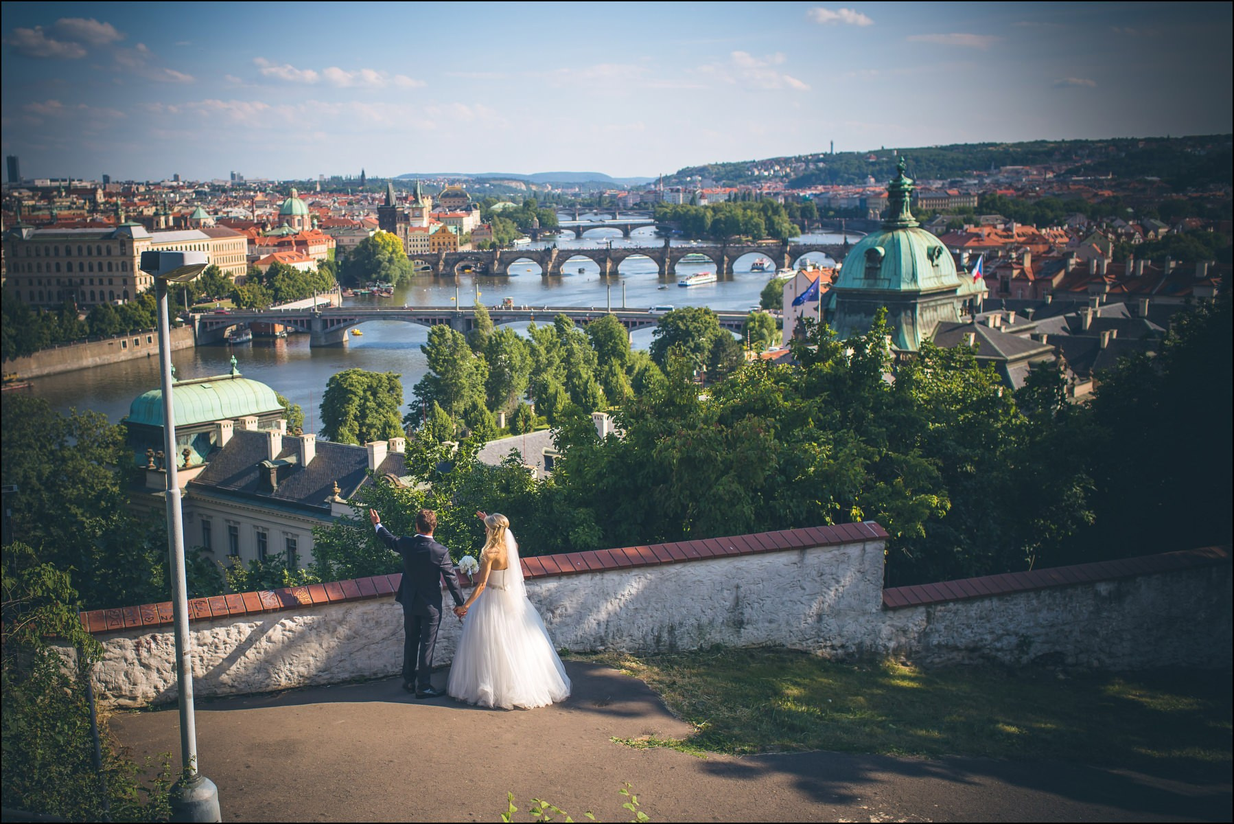 Couple enjoying panoramic view of Prague from Hanavský Pavilion wedding portraits