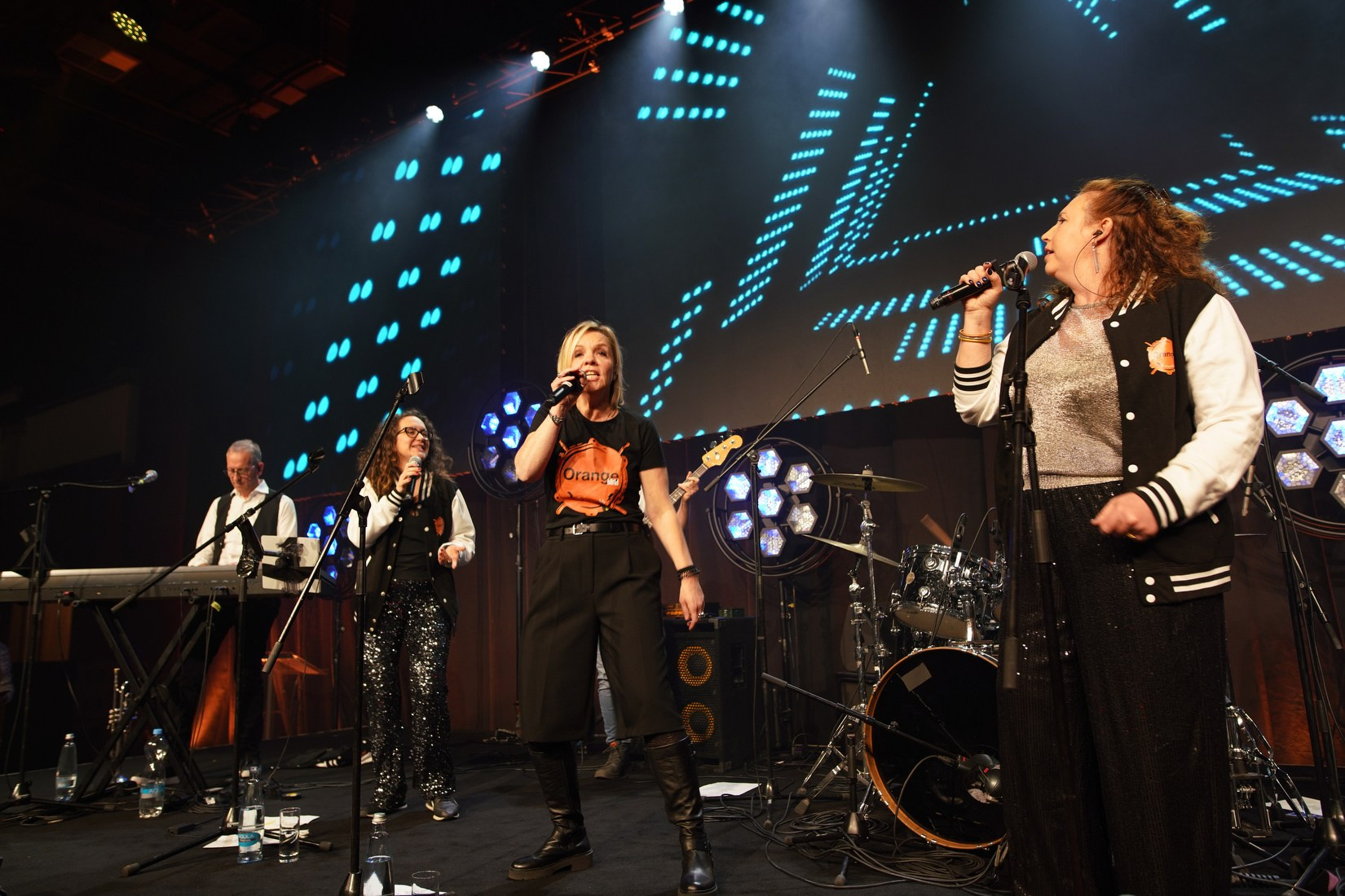 Orange Band live performance on stage adventure-themed gala Orange Business Sales Kick-Off 2026 Hilton Prague.