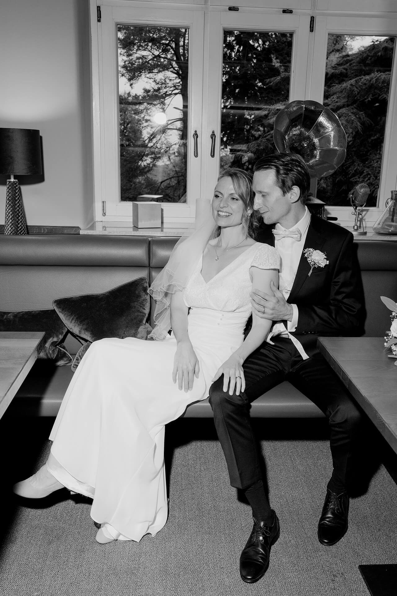 Black and white couple seated indoors, reception at Falkenstein Grand