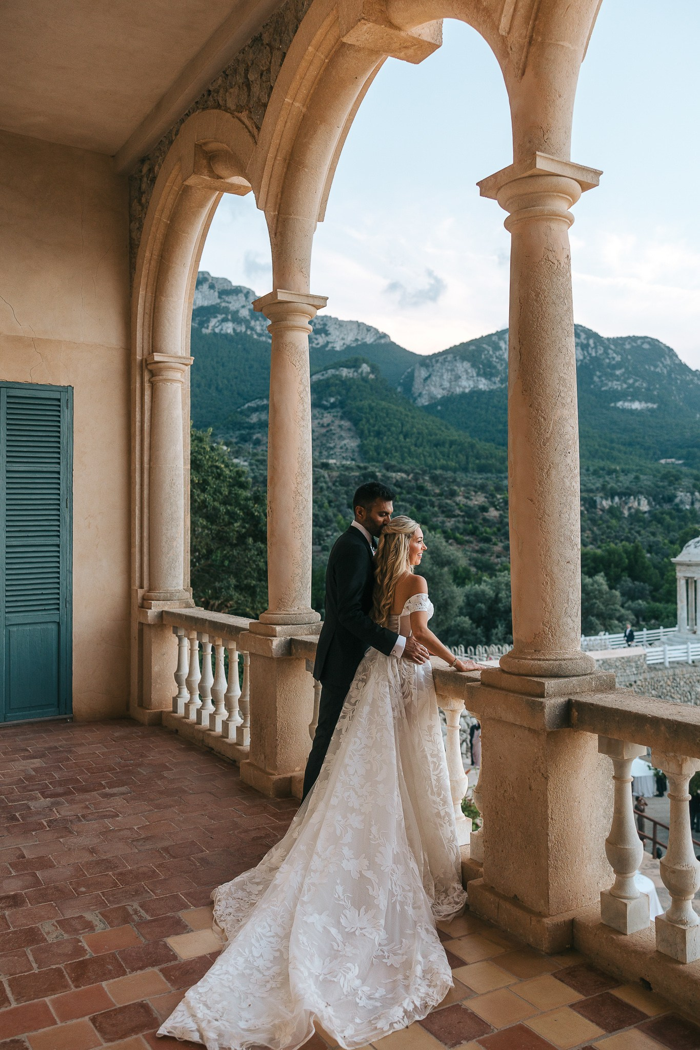 Bride and groom sharing a quiet moment on the balcony at their luxury Mallorca wedding venue