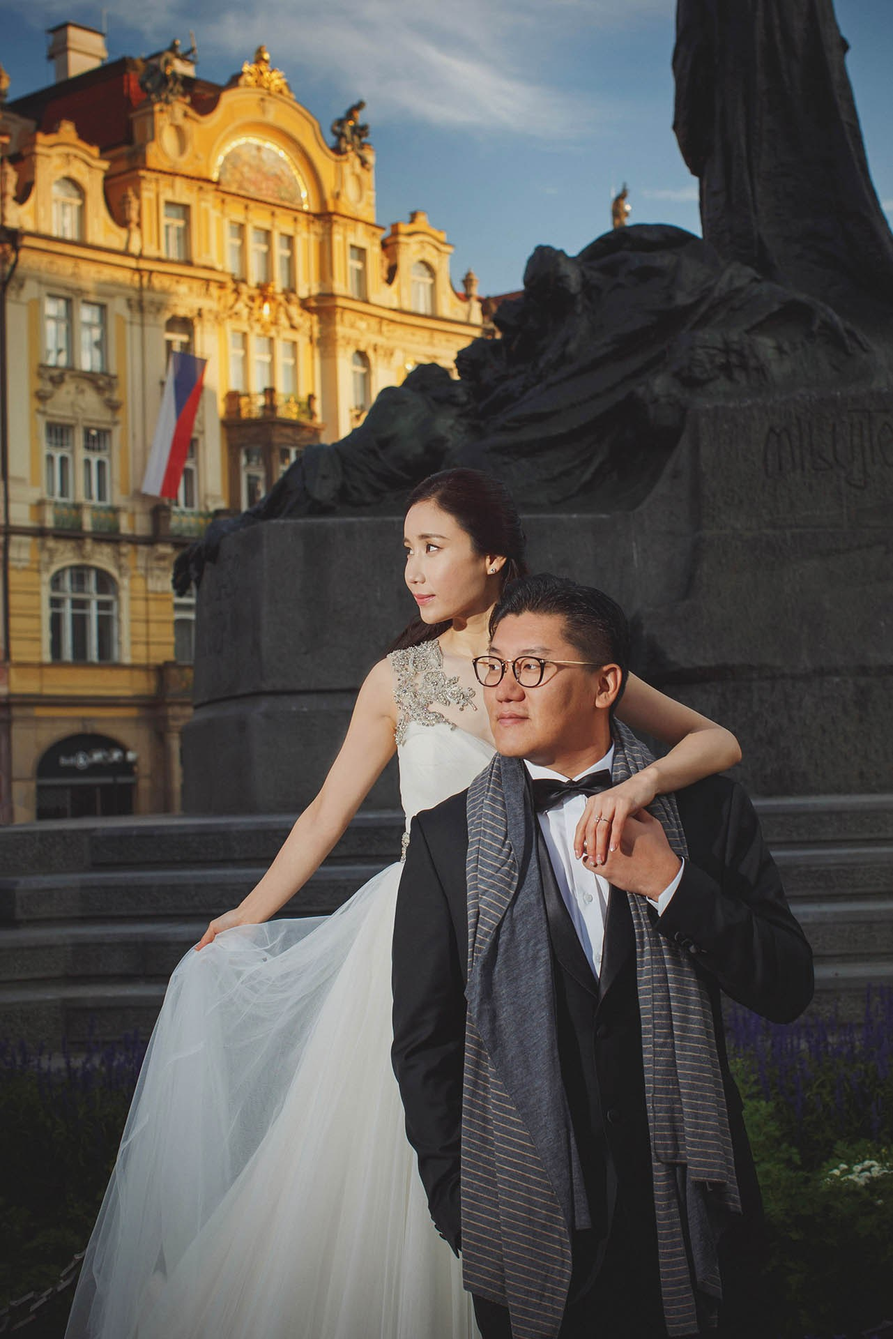 Catherine Cedric Son hand hold Old Town Square sunlight Prague portrait.