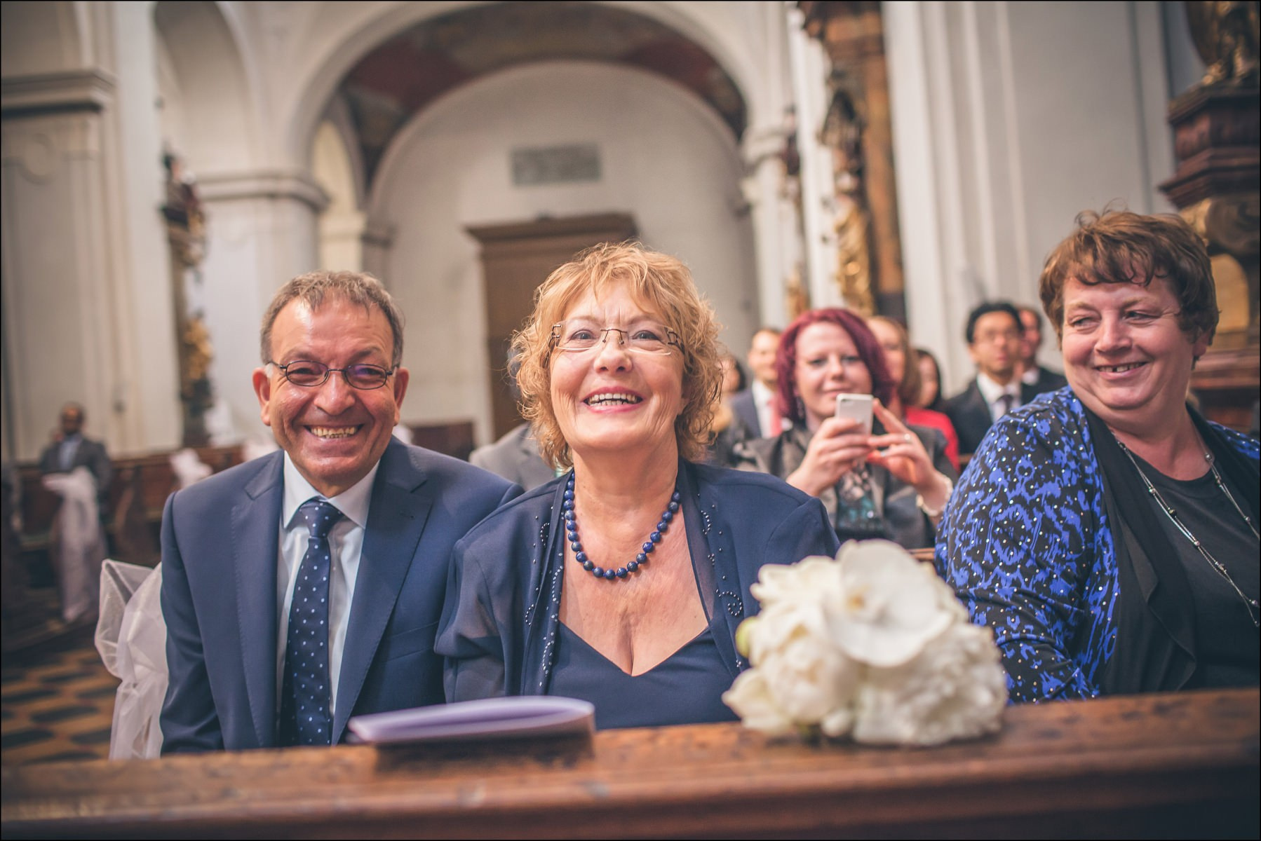 Proud parents of bride watching ceremony at St. Thomas Prague