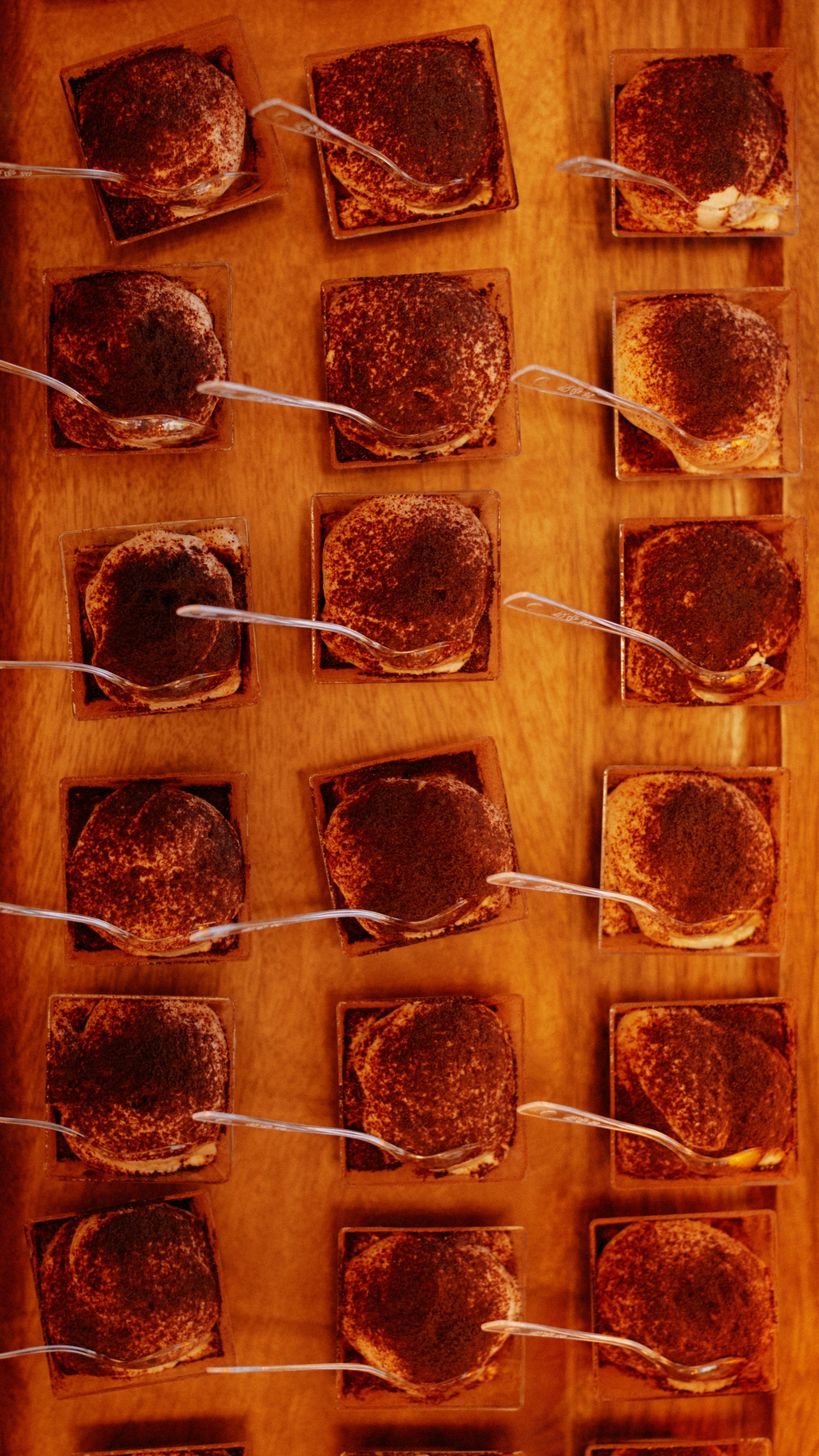 Rows of cocoa-dusted dessert cups on a wooden tray at the PayTech Women Vancouver reception