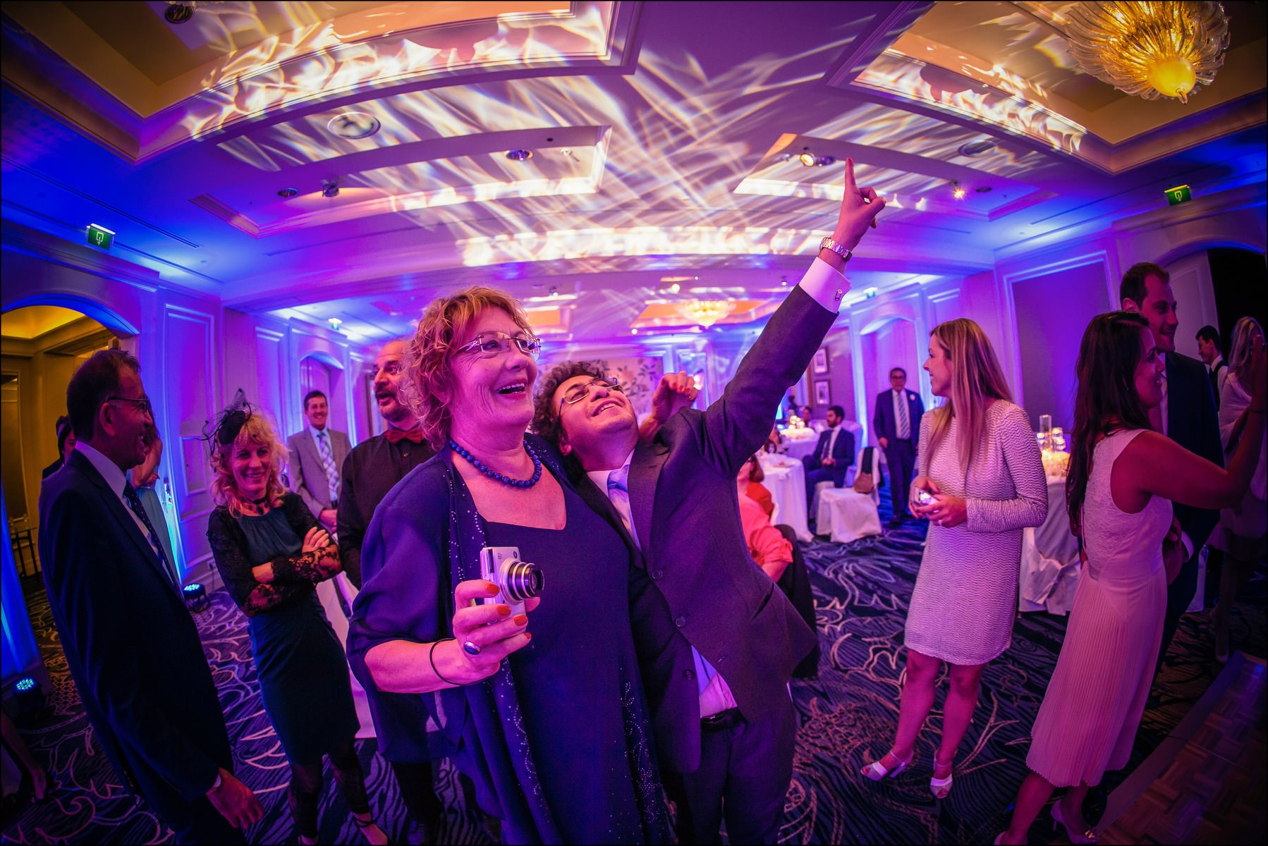 Wedding guests toasting bride and groom during dinner Prague