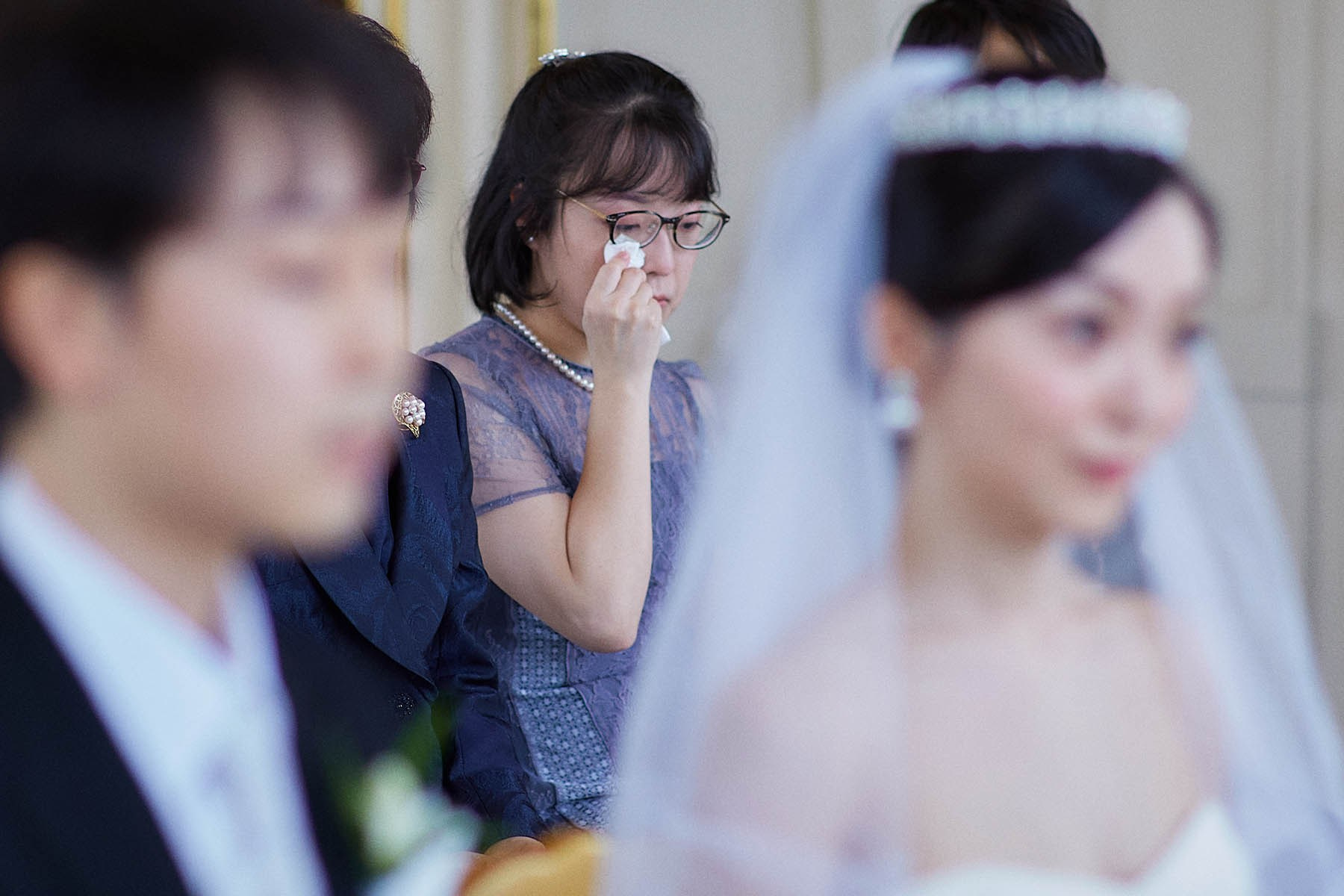 The bride's sister shares a tear.