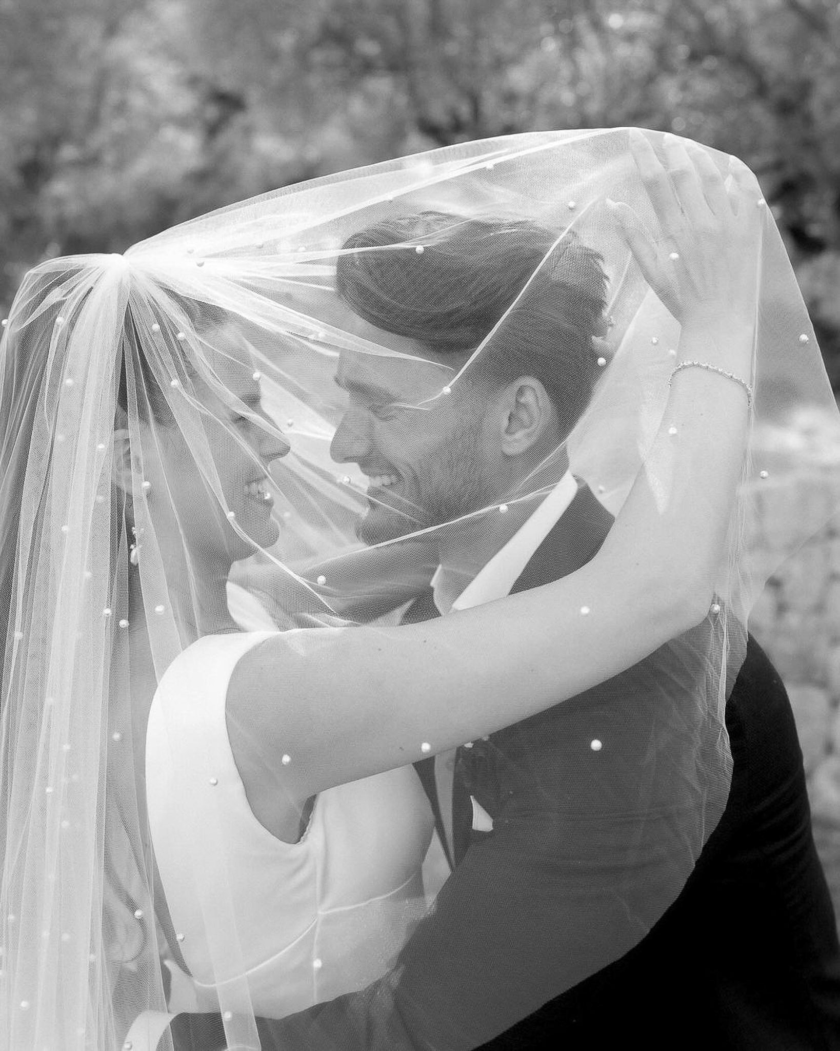 Bride and groom sharing an intimate kiss on the forehead at their Mallorca wedding