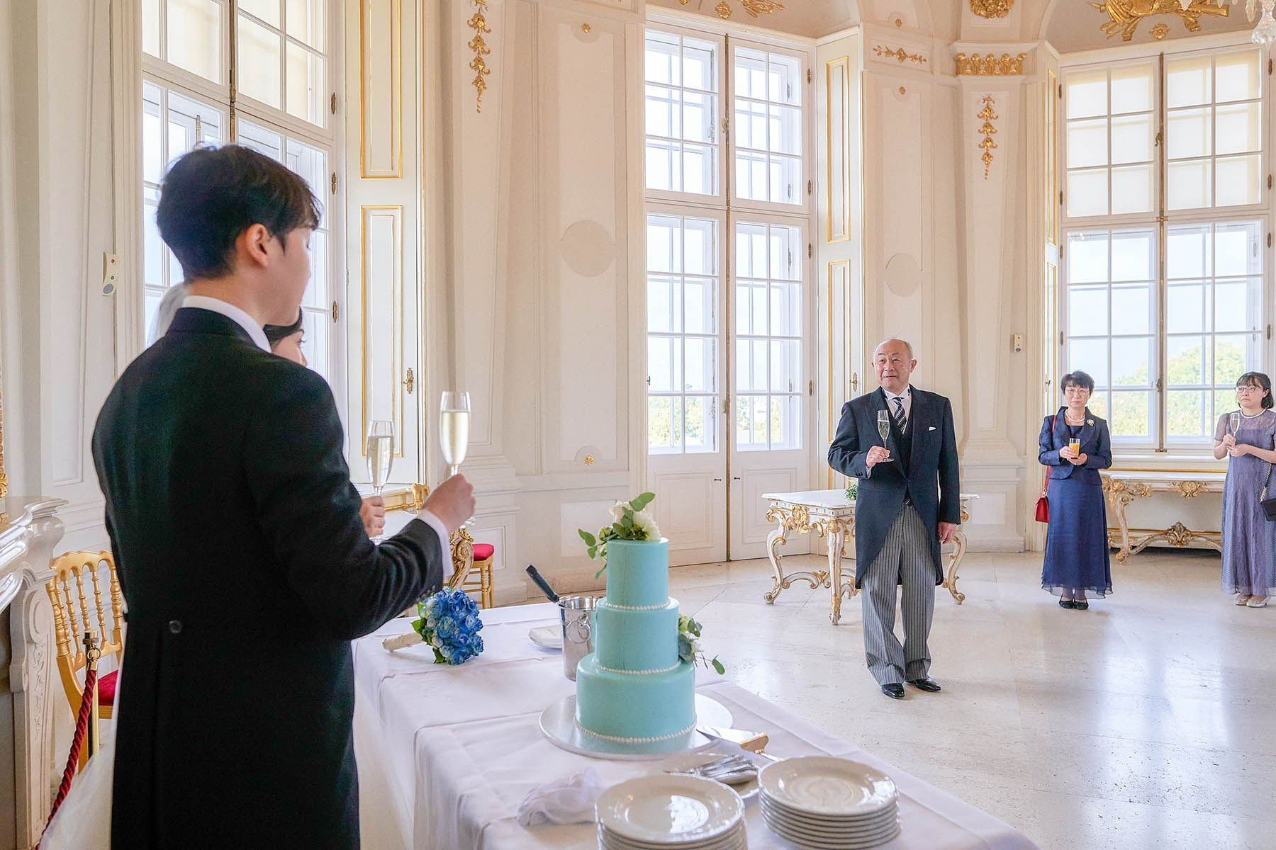 Bride's father giving speech with champagne at Belvedere Palace wedding.