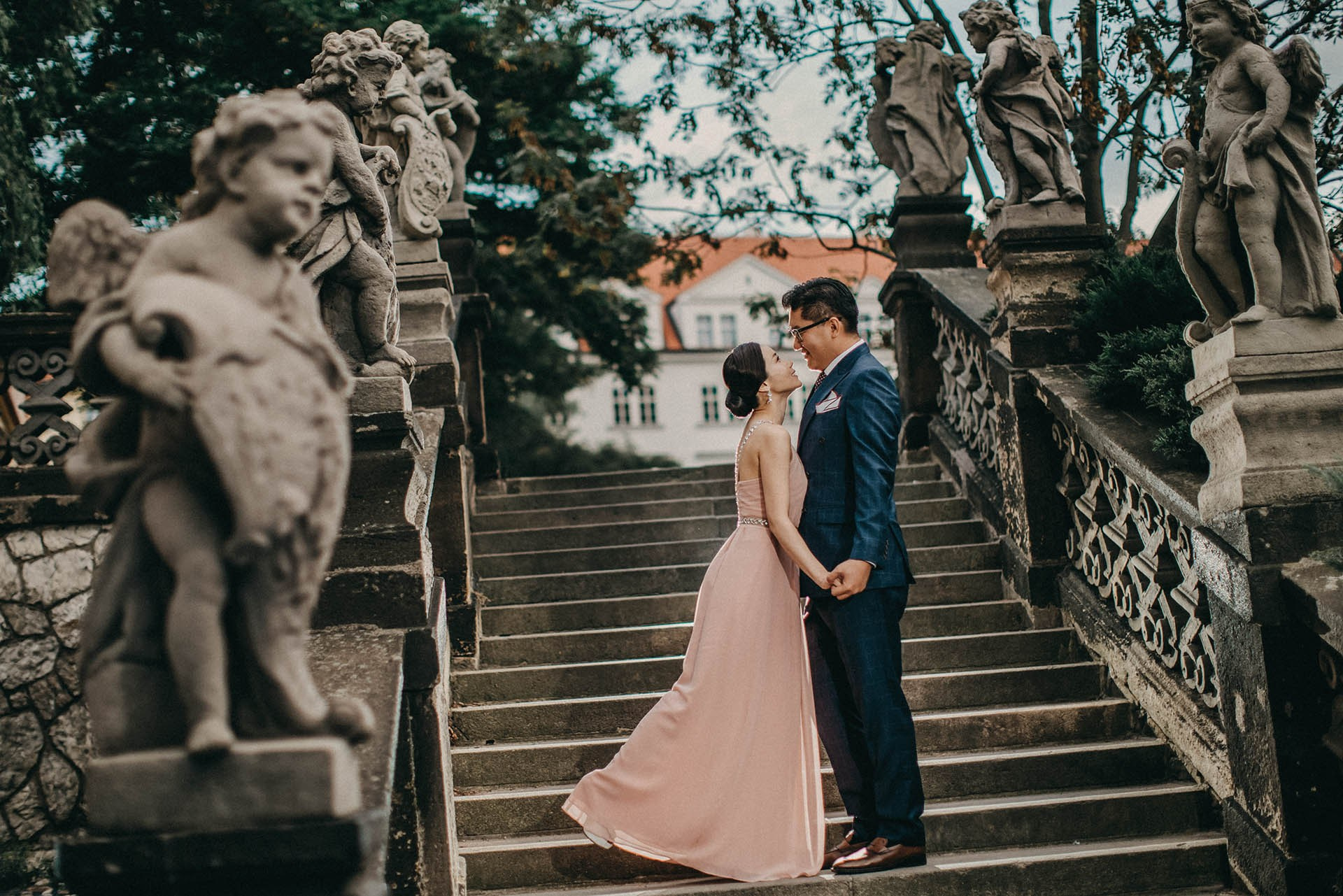 Catherine Cedric Son embrace Loreta statues Prague Castle portrait.