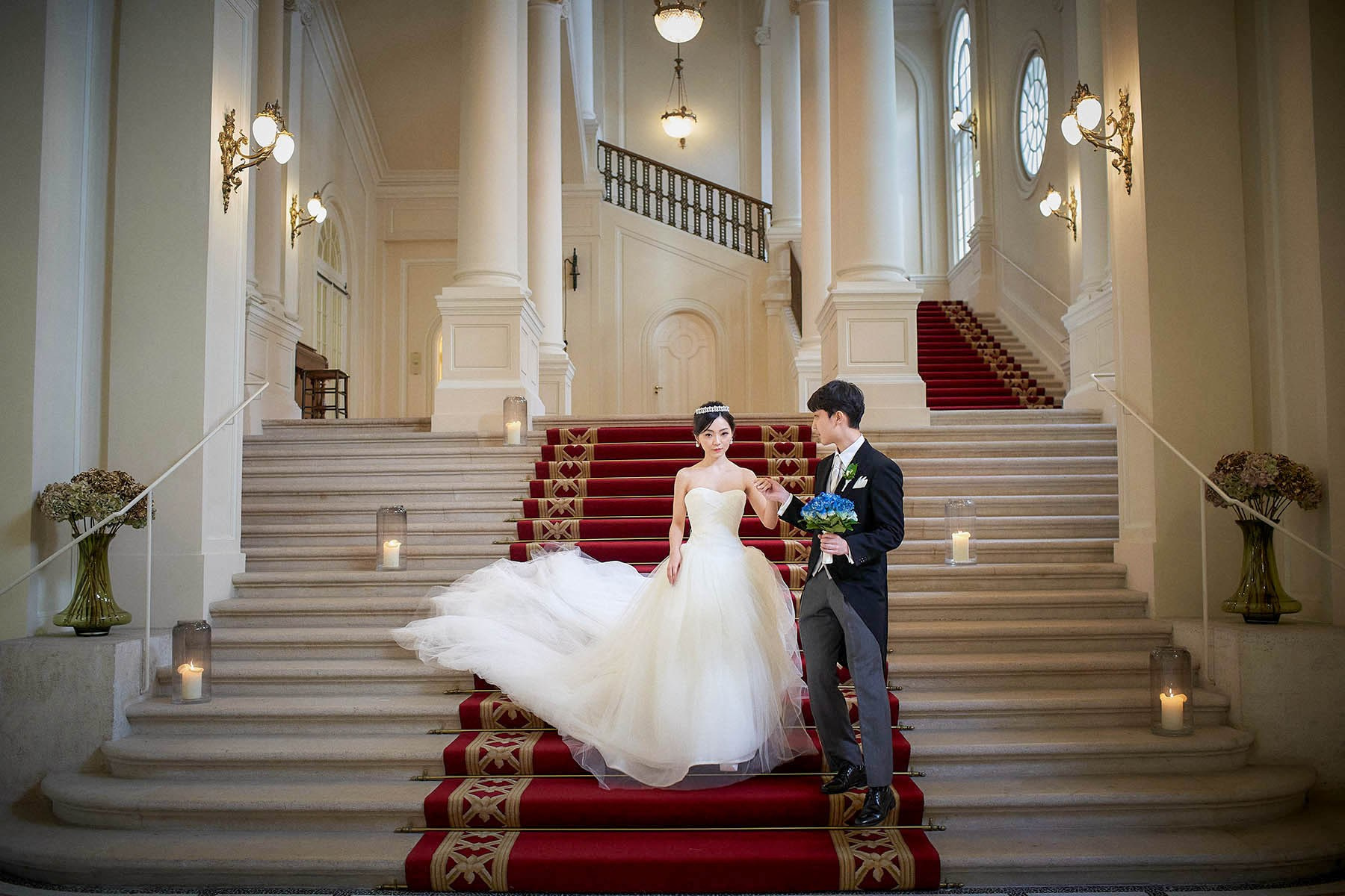 Before taking her by the hand to lead her down the steps.