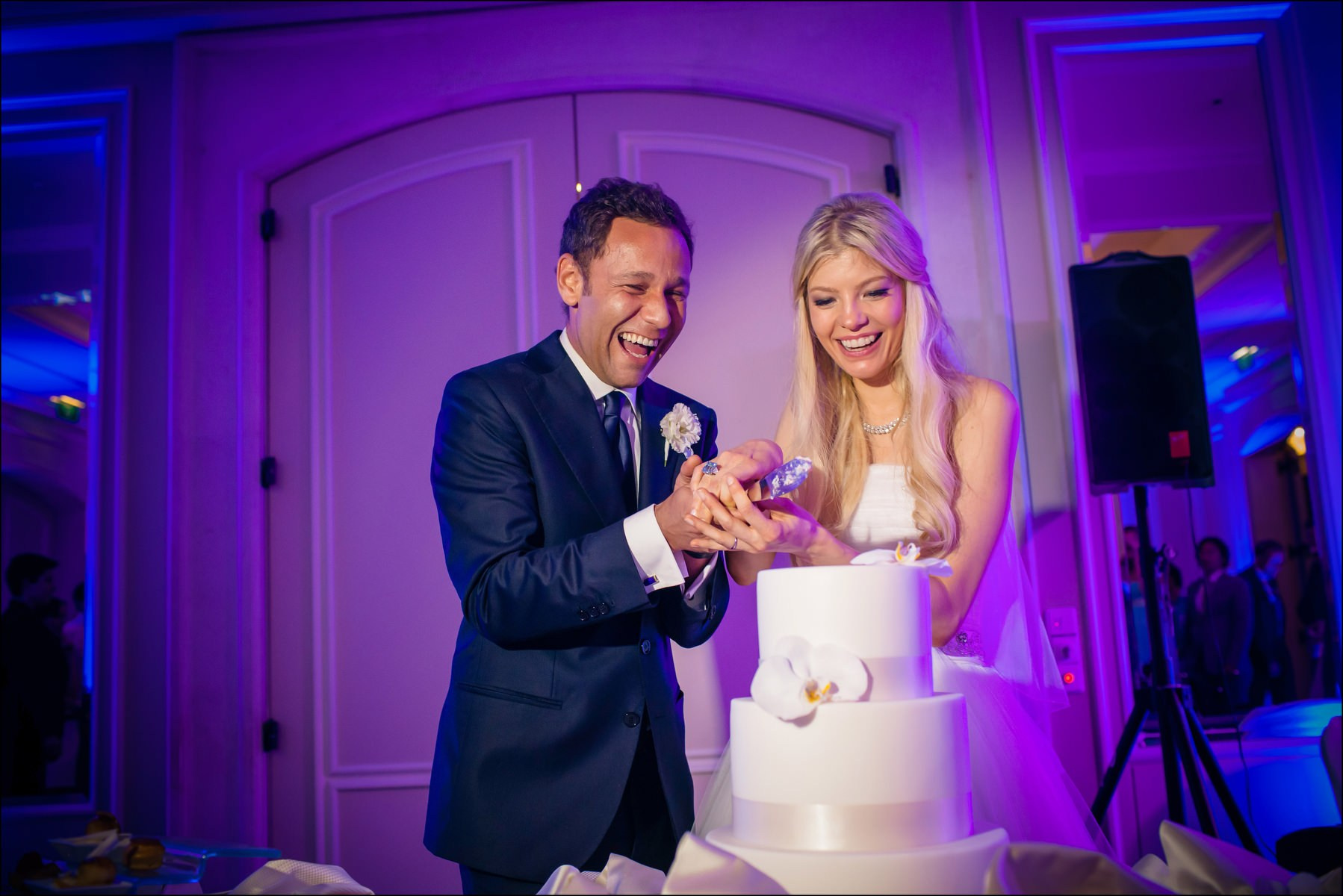 Newlyweds at cake cutting moment Four Seasons Prague reception