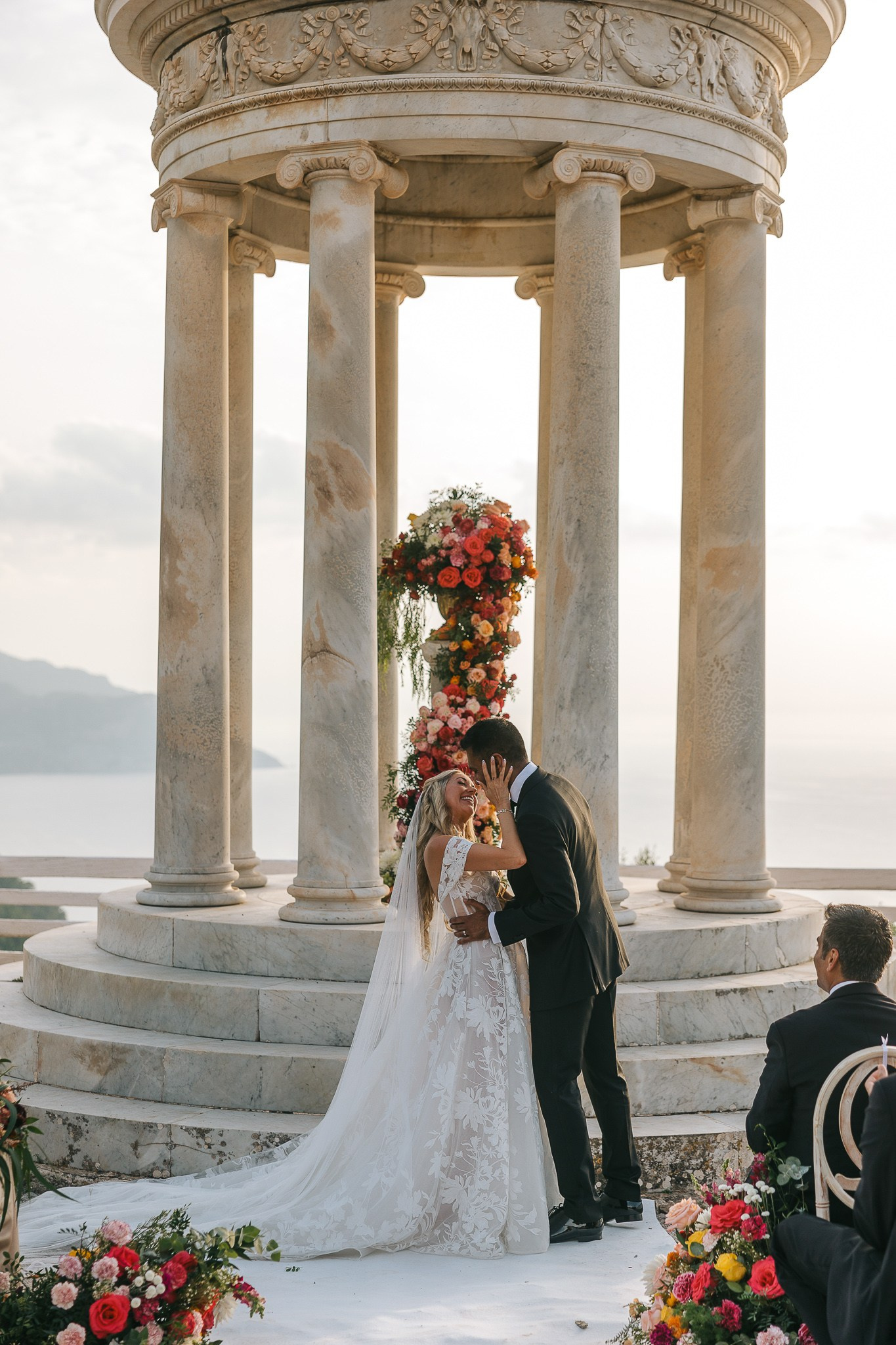 Bride and groom embracing at the Son Marroig temple after their wedding officiant pronounced them married