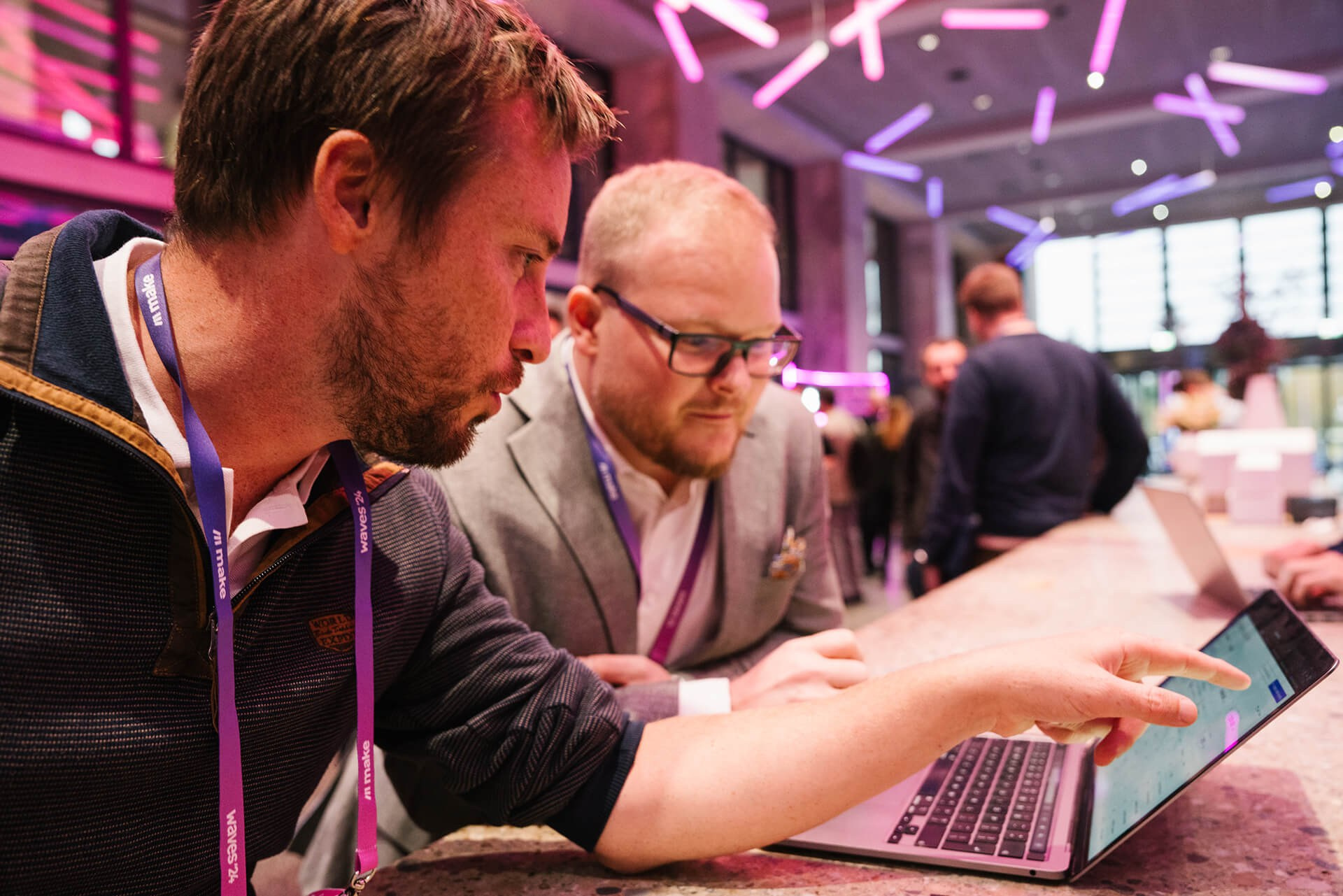 Small group collaborating on laptops during a workshop session