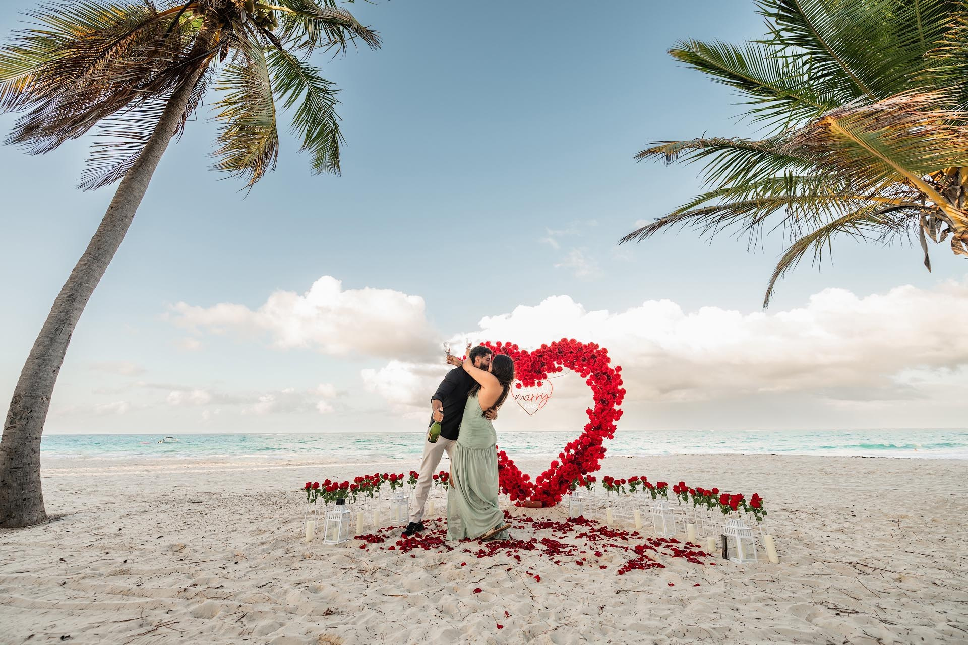 Romantic beach proposal with red floral heart in Punta Cana