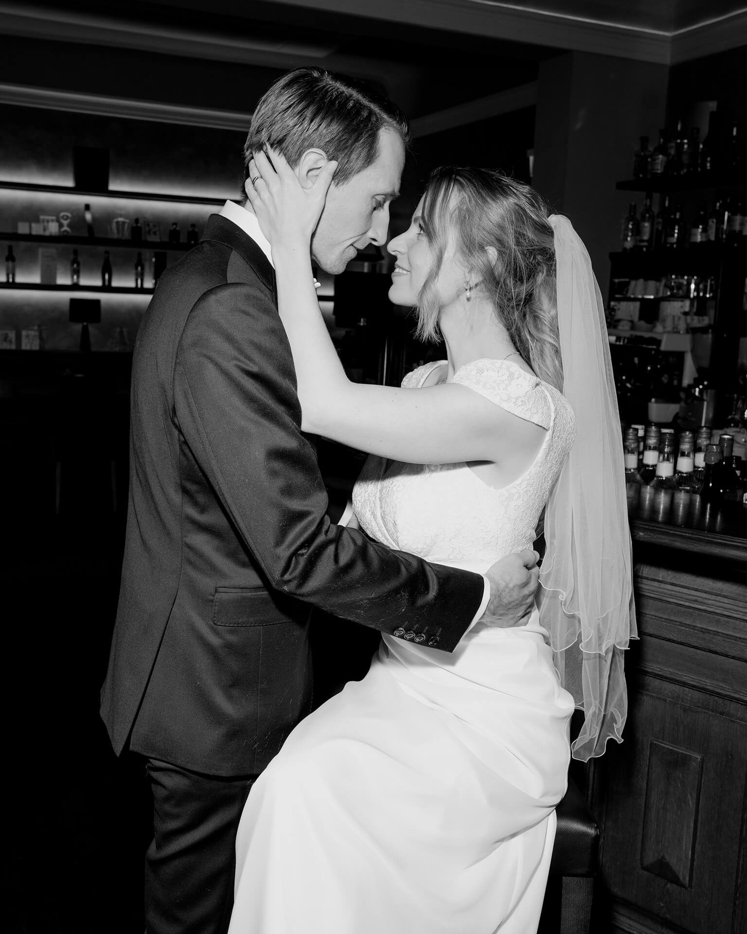 Black and white couple embracing, reception moment at Falkenstein Grand