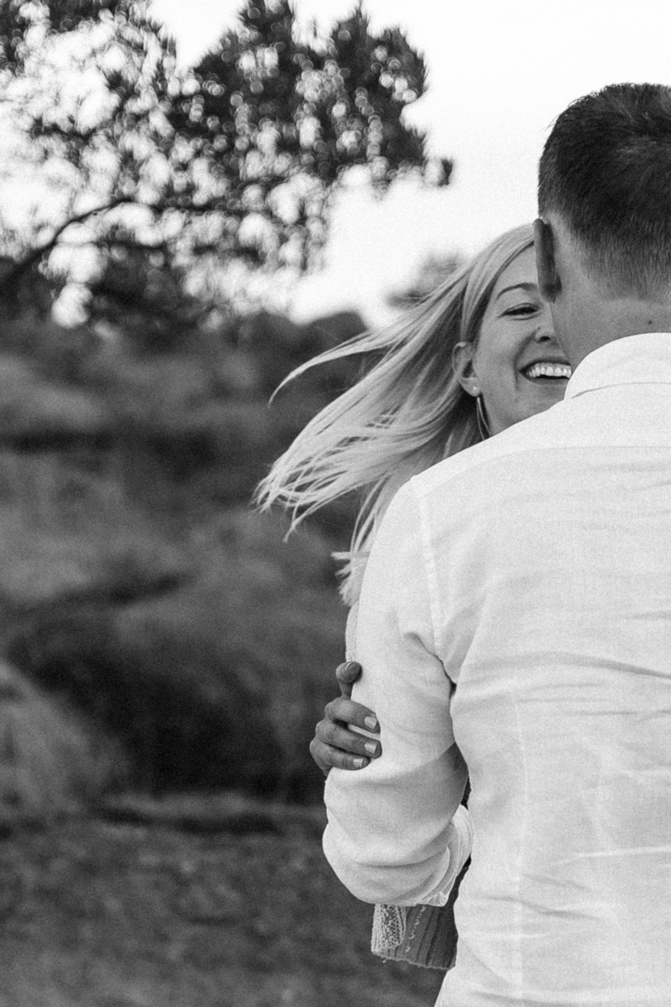 dynamic couple photoshoot with emotions and smile outside in the mountains