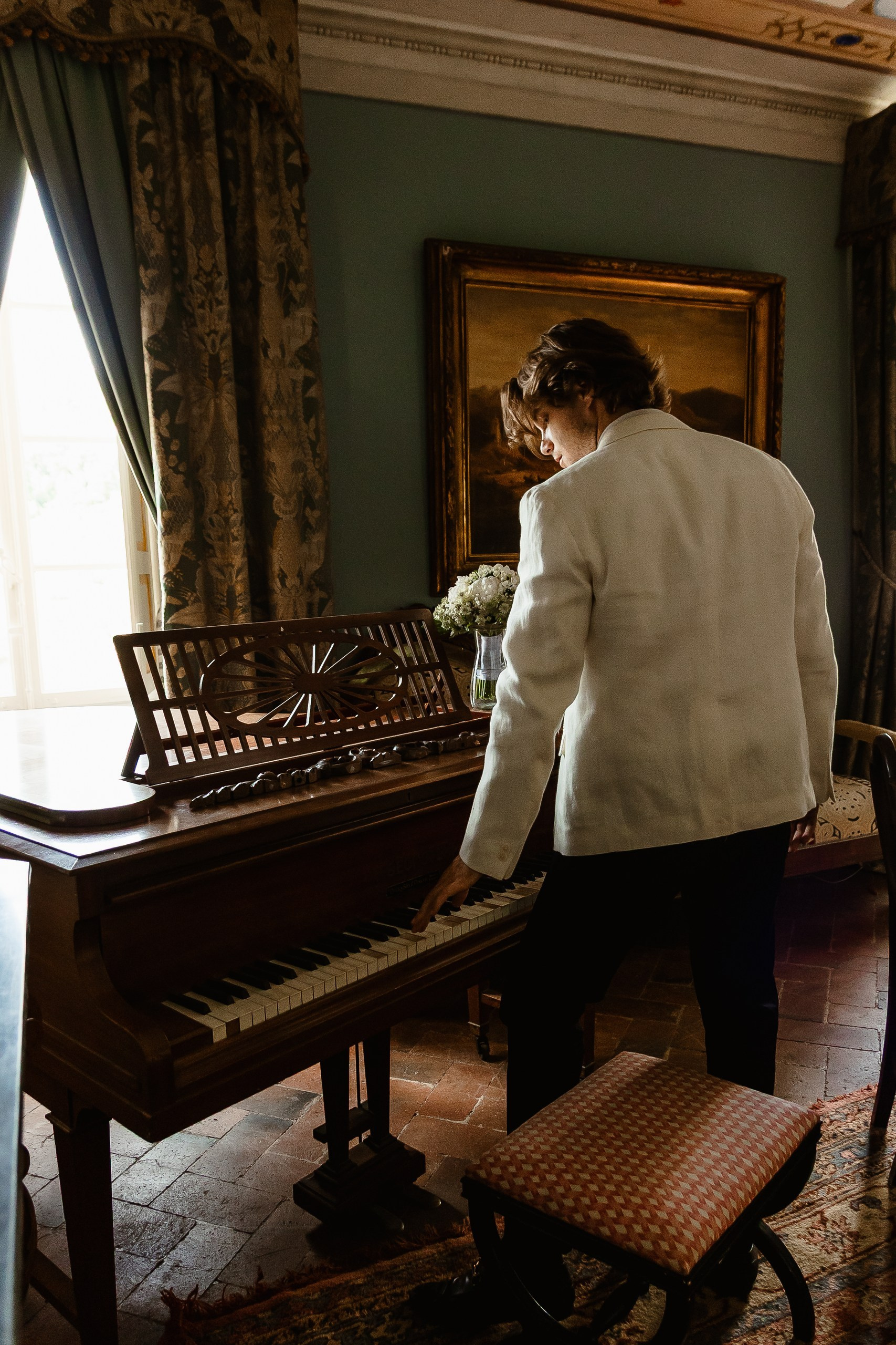 Hrom playing piano in antique villa in Tuscany