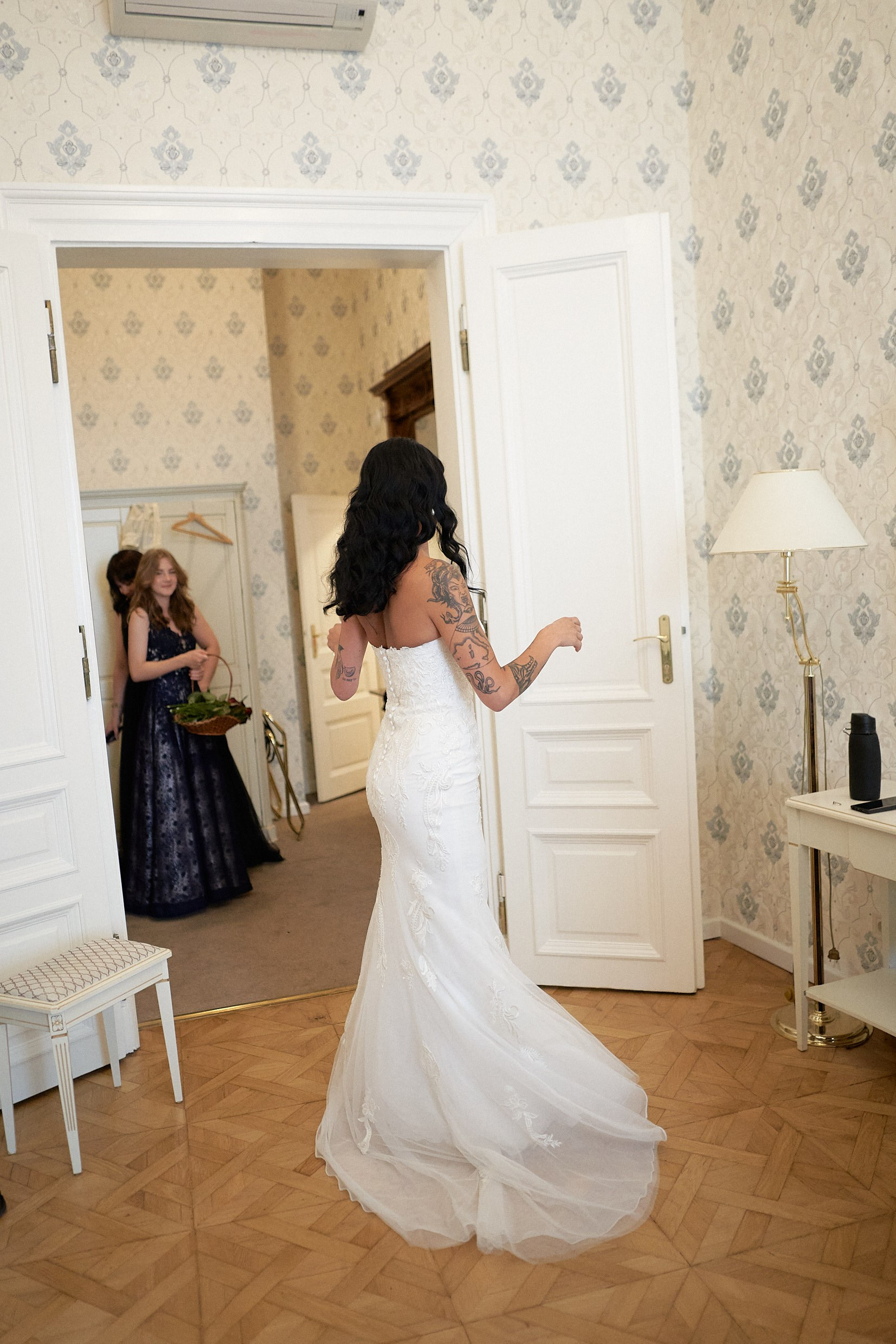 Bride taking tentative first steps in custom wedding dress Prague.