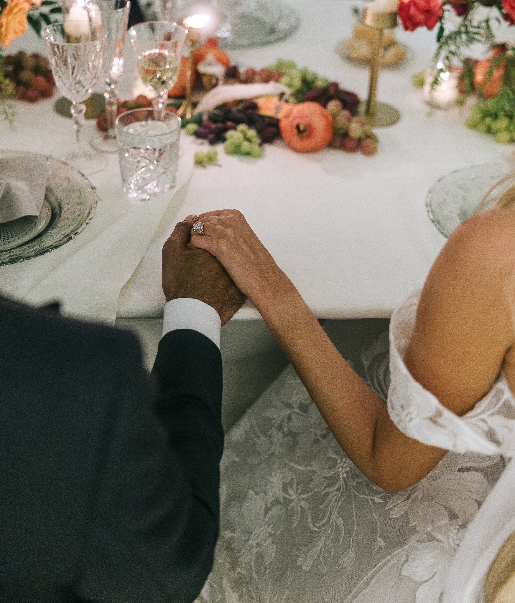Bride and groom laughing and holding hands at their reception table at their Mallorca wedding