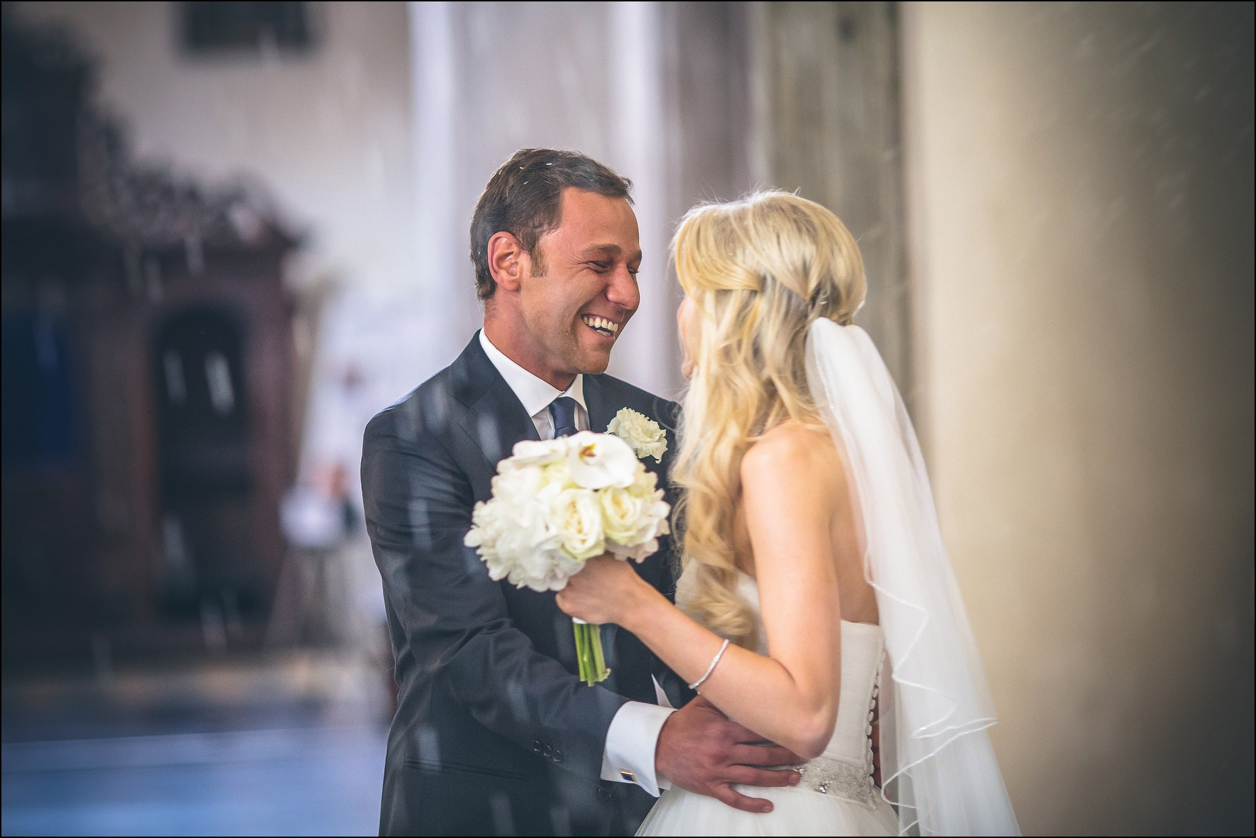Traditional rice toss for newlyweds exiting Prague church wedding