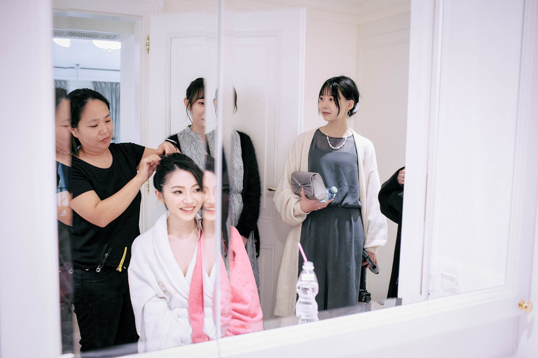 The bride-to-be is all smiles as her friends join her upstairs to check on her.