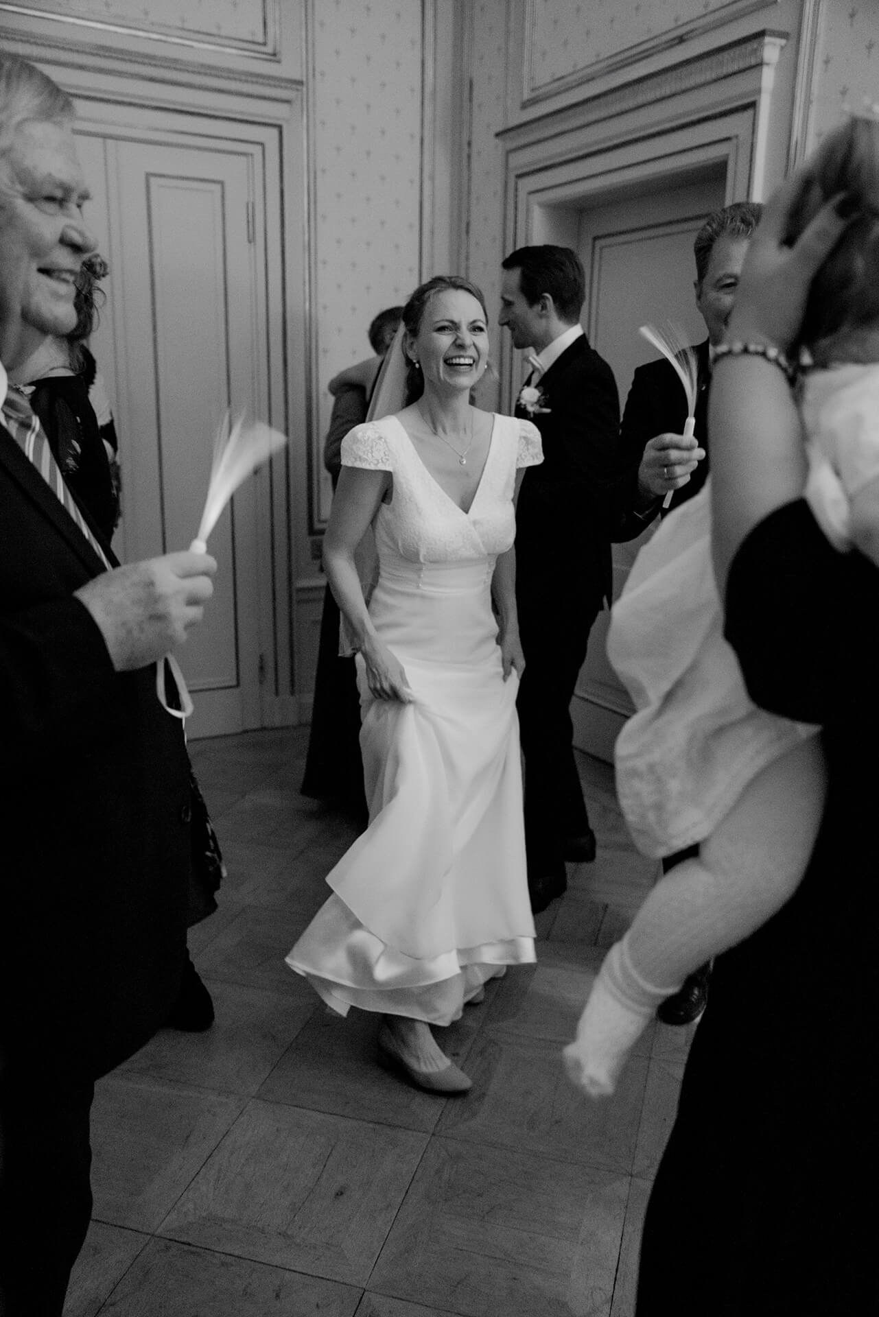 Black and white bride dancing with guests at luxury wedding reception
