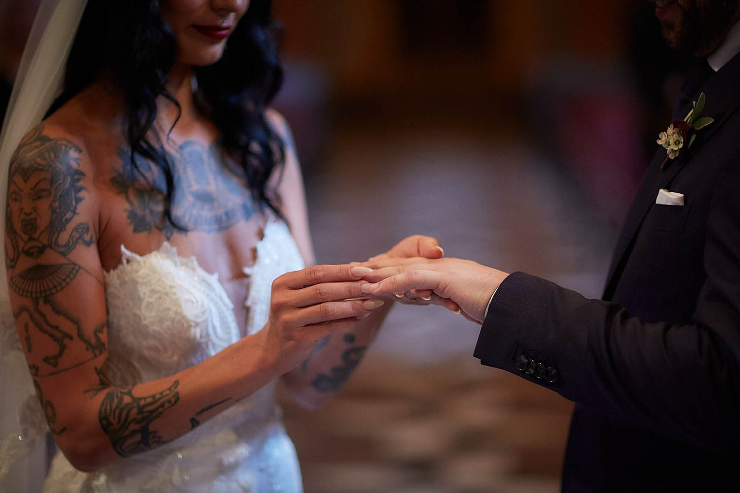 Bride placing the ring on the groom's finger during the Klementinum exchange.