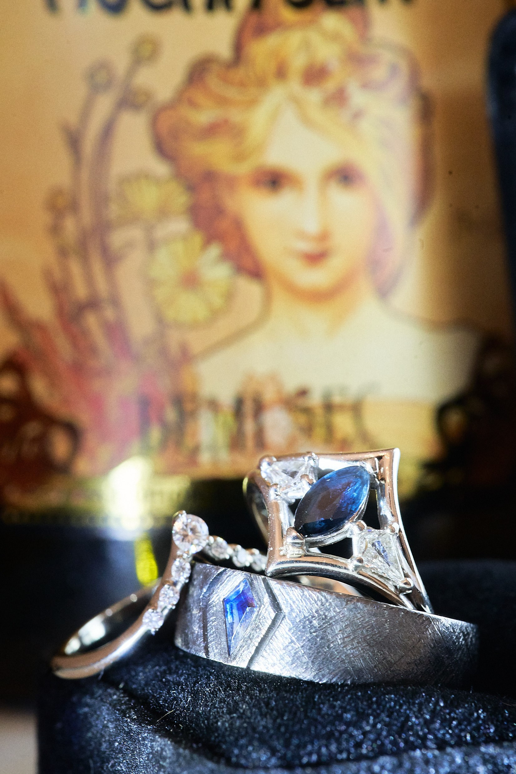 Engagement ring beside Alfons Mucha artwork in gothic bridal suite Prague.